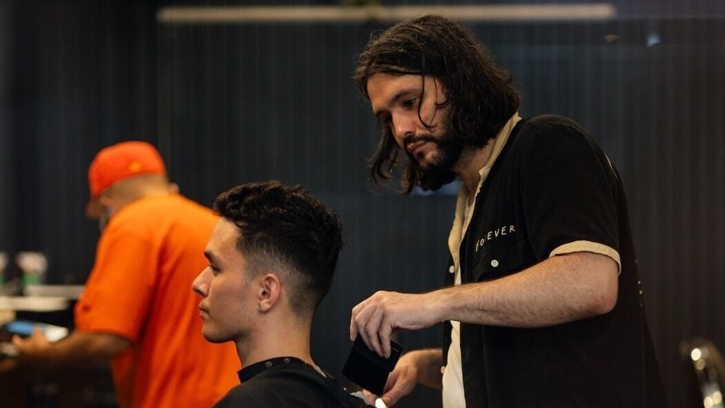 Experienced stylist at Kev Farquhar | Barber, Surry Hills, giving a haircut. Surry Hills, New South Wales, AU.