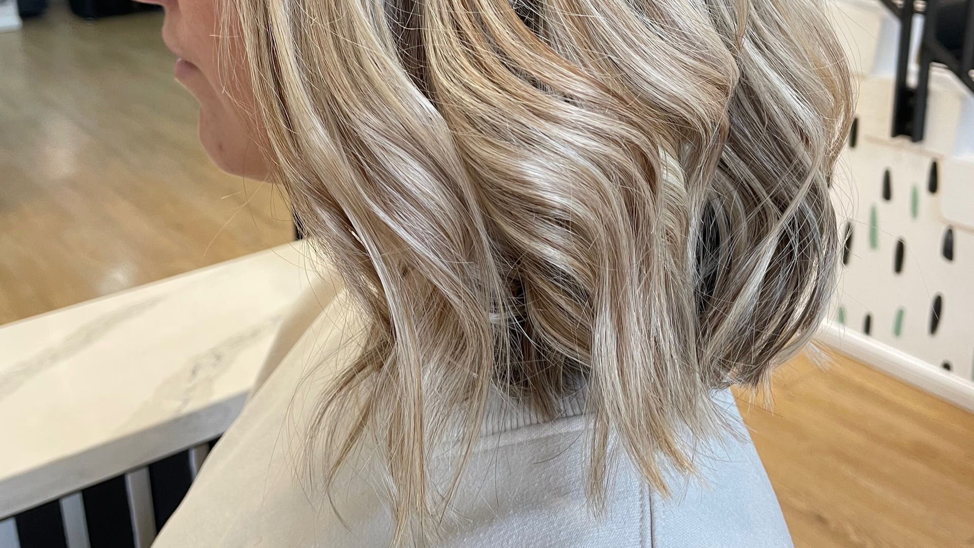 Chloe Mitchell Hair in Glasgow, Scotland, GB showcases elegant blonde curls in a chic bob style.