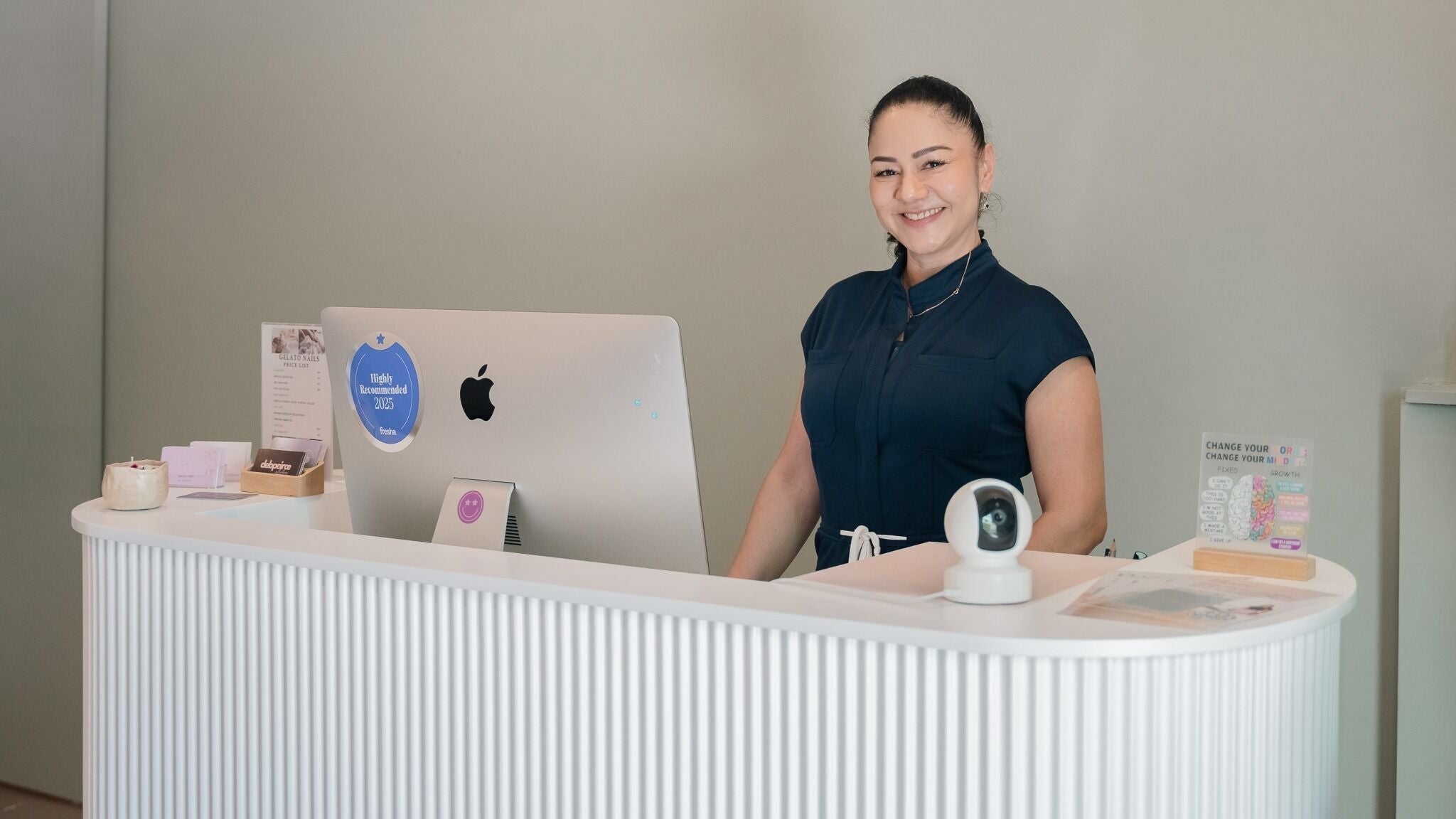 Receptionist at Grace Wellness Studio in Subiaco, Western Australia, AU, warmly welcomes guests.
