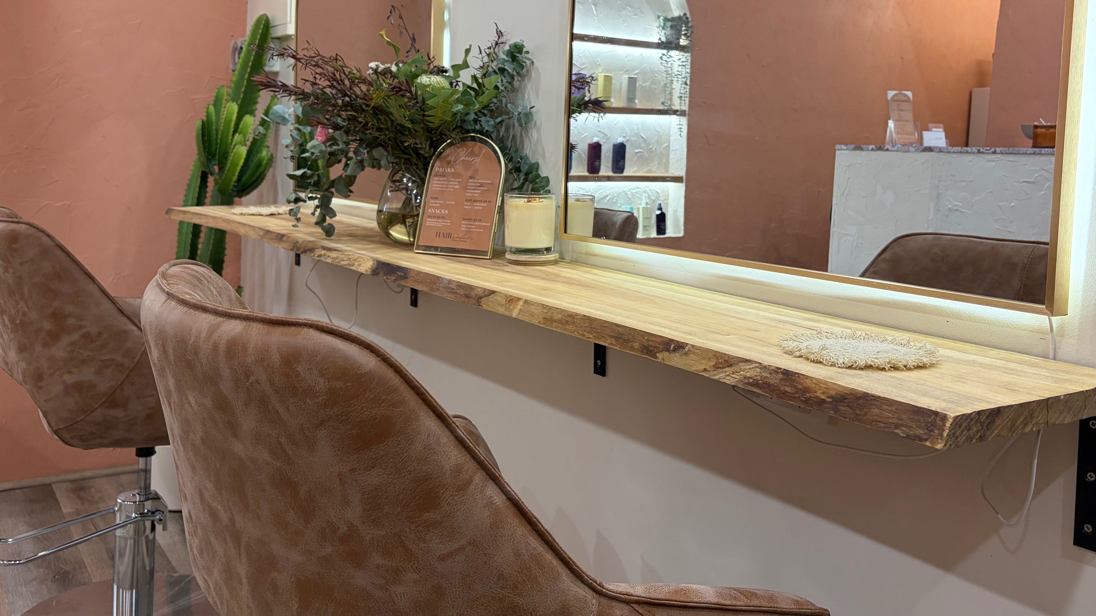 Trendy interior at Hair Safari, Wakerley, Queensland, AU with a stylish salon setup and cozy leather chairs.