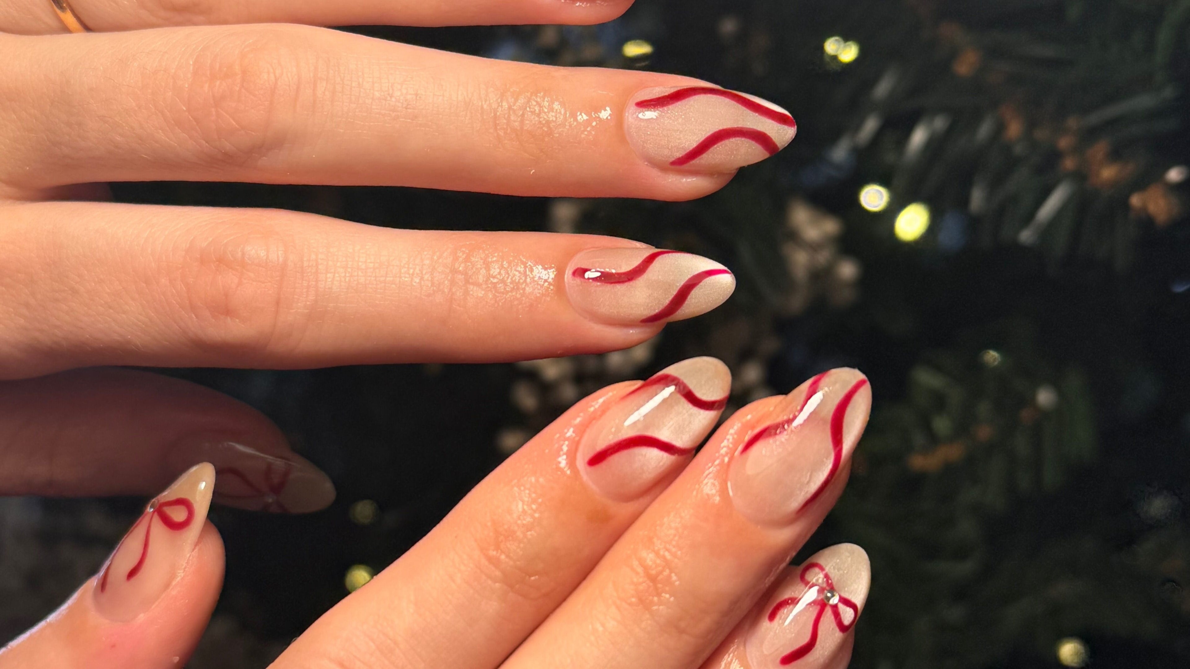 Elegant nail art with red swirls at The Nail Booth by Marnie, Kelvin Grove, Queensland, AU.