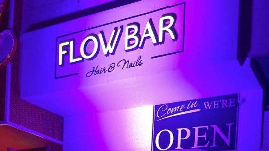 Flowbar entrance sign illuminated with vibrant lighting in Riyadh, Riyadh Province, SA.