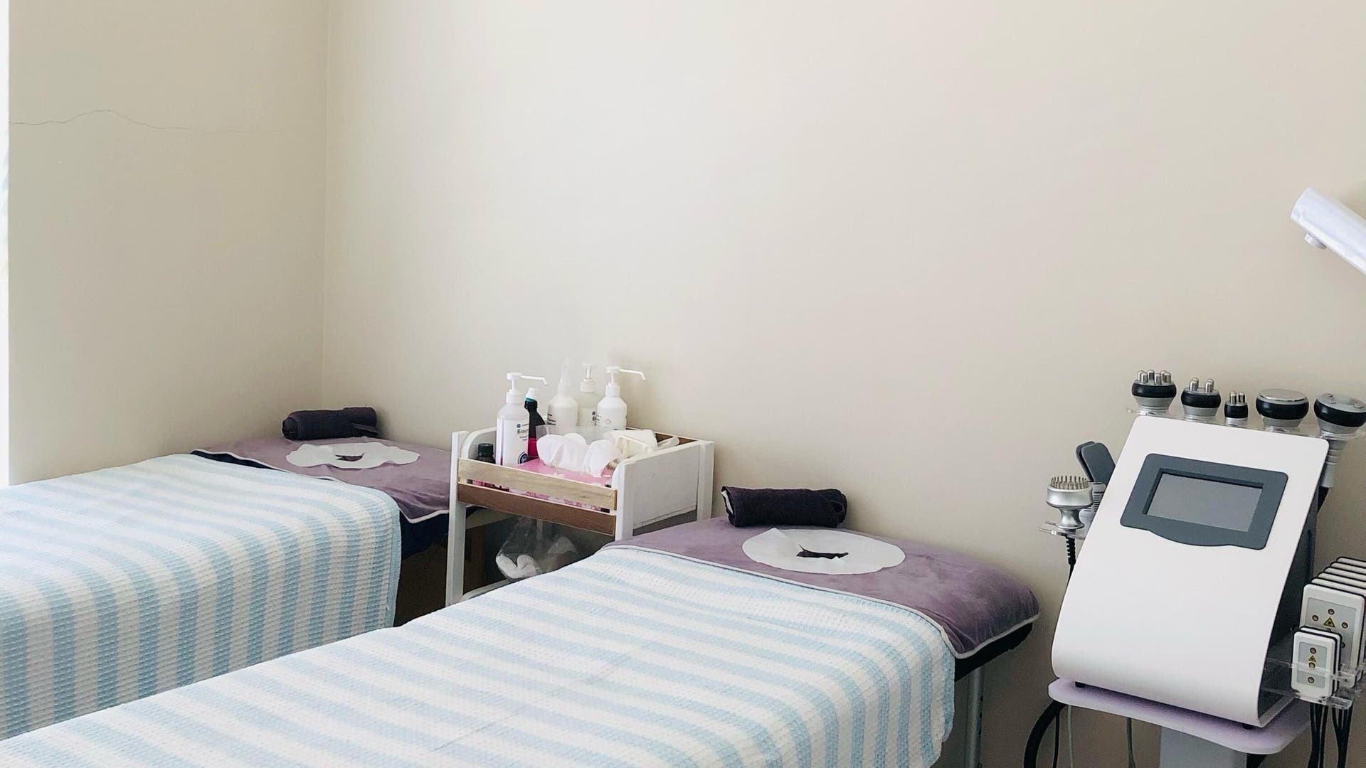 Cozy treatment room at Azraa's Wellness Healing, Cape Town, Western Cape, ZA with twin beds and modern equipment.