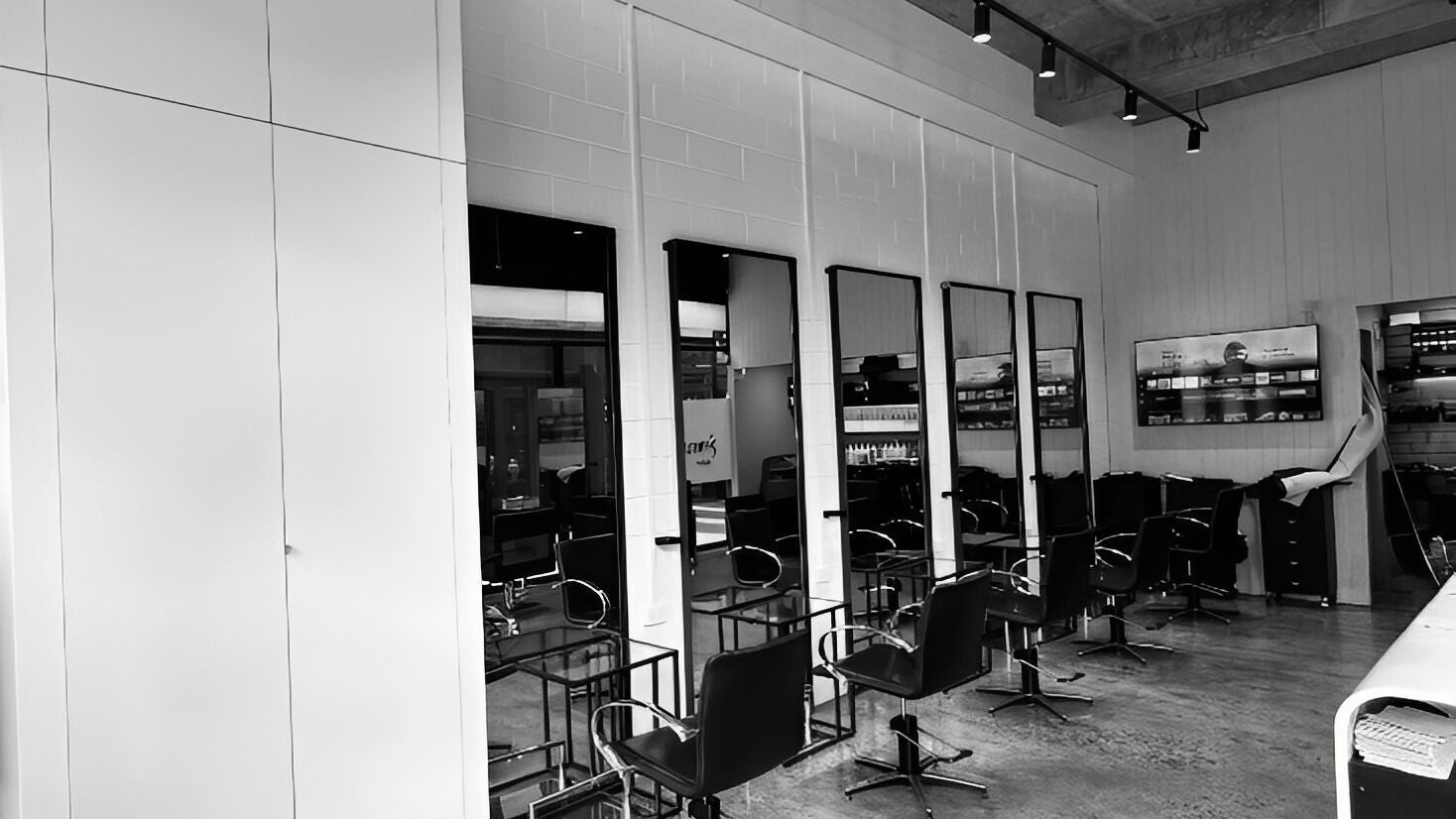 Modern salon at Mancini & Co, Prahran, Victoria, AU, featuring sleek styling stations and mirrors.