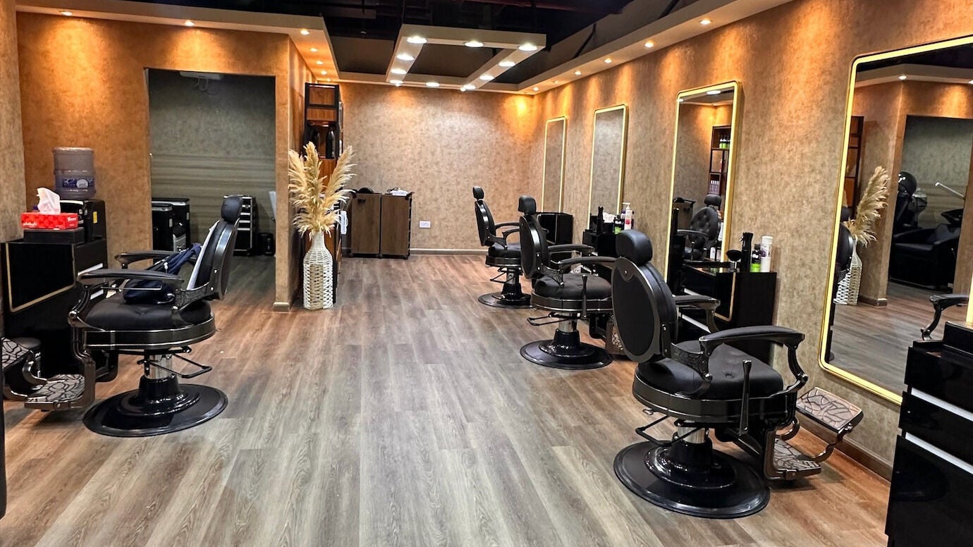 Modern beauty salon interior at Barkat Hair Lounge, Dubai, AE with stylish hair stations and mirrors.