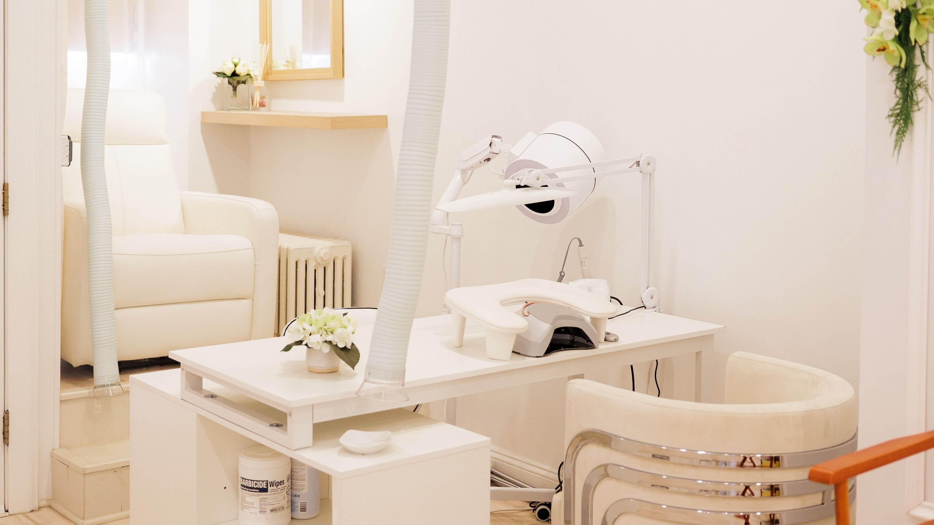 Cozy white treatment room at IM salonspa, Dobbs Ferry, New York, US with modern equipment and inviting seating.