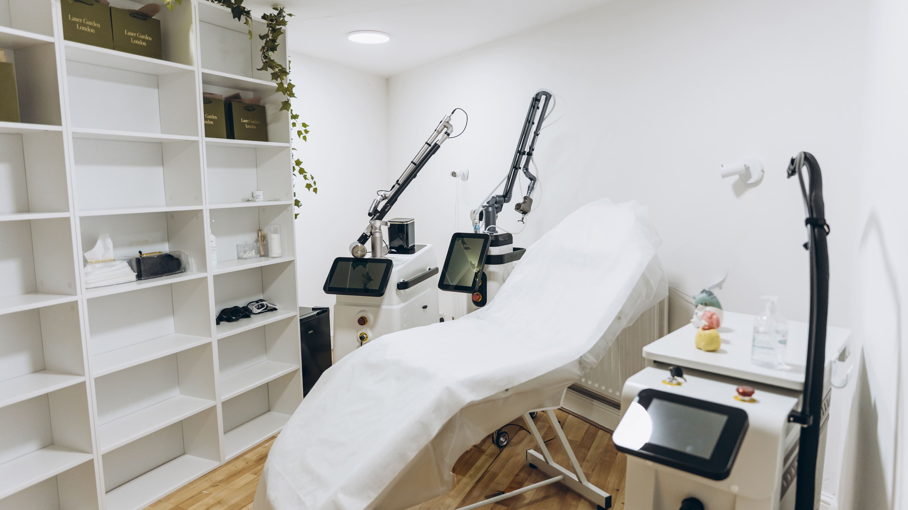 Modern laser treatment room at Laser Garden, London, England, GB showcasing advanced equipment and calm ambiance.