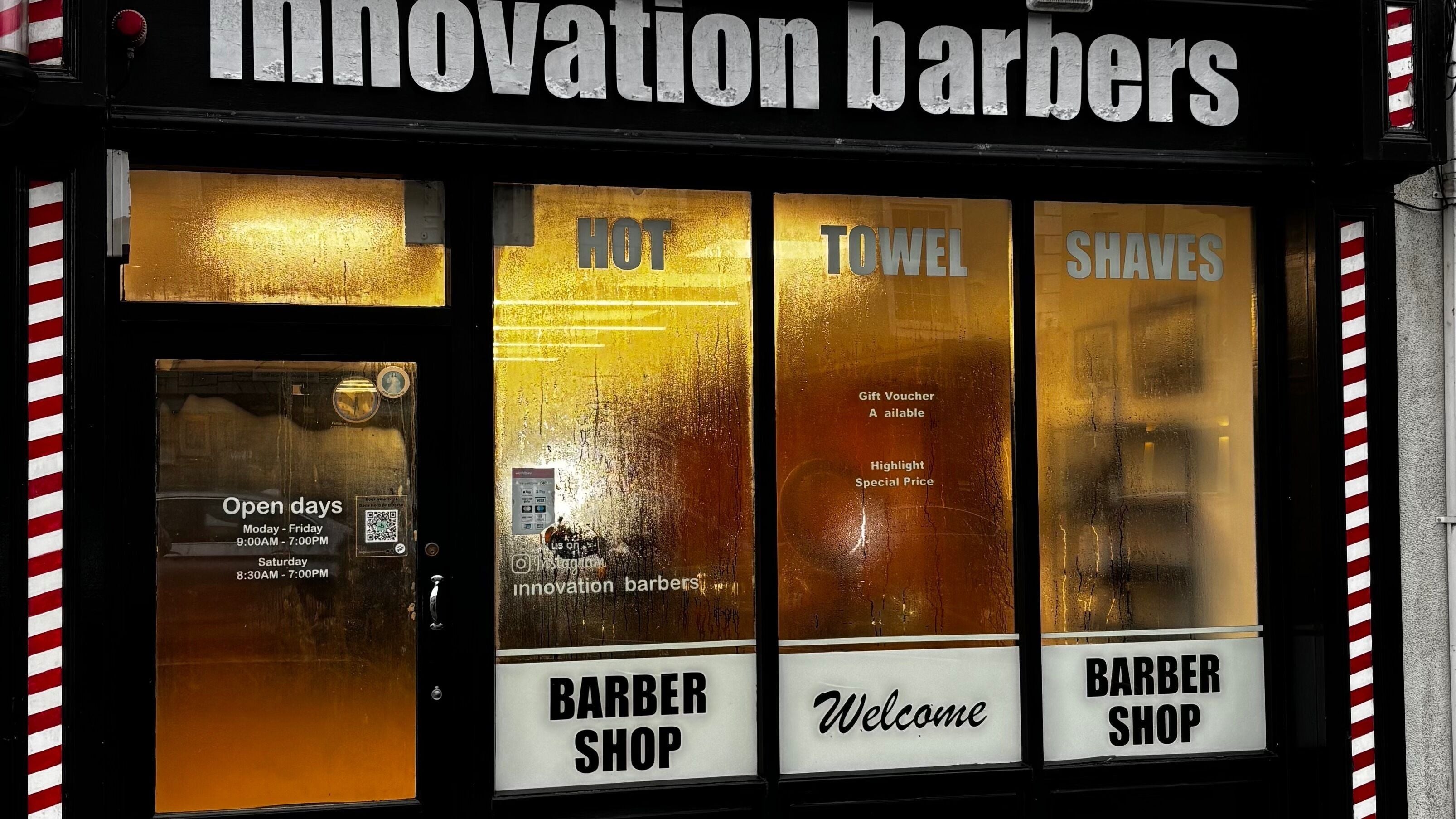 Front view of Innovation Barbers in Gort, County Galway, IE with illuminated signage and welcoming windows.