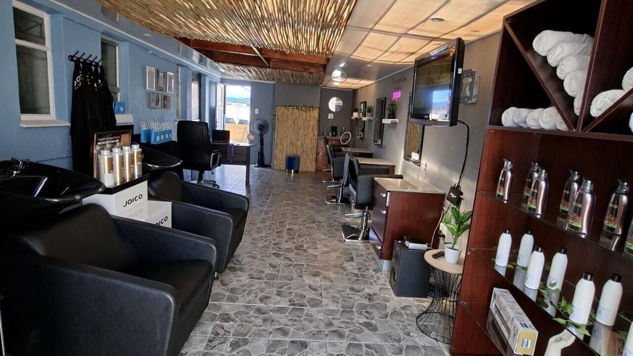 Elegant interior of Living Water Hair Studio in Cape Town, Western Cape, ZA with stylish chairs and products.