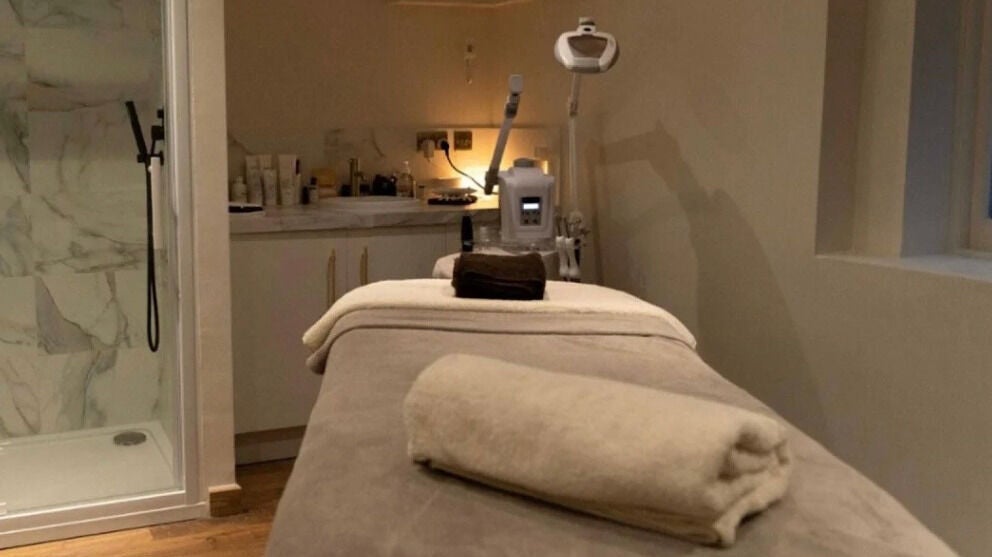 Relaxing spa treatment room at Forbici London, London, England, GB with cozy table and modern equipment.