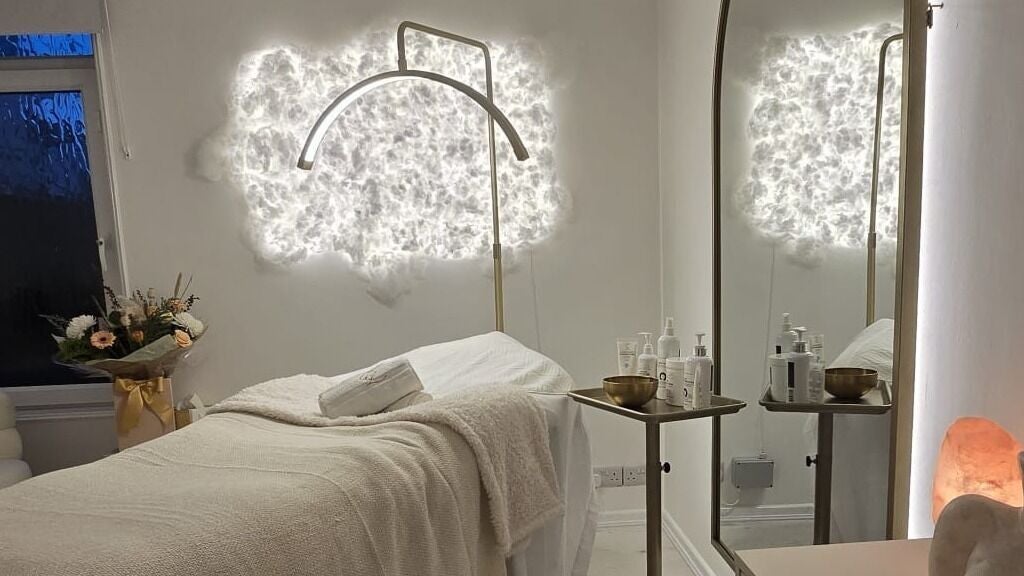 Elegant treatment room at ReBourne Nurse Aesthetics, Eastbourne, England, GB, with ambient lighting and decor.