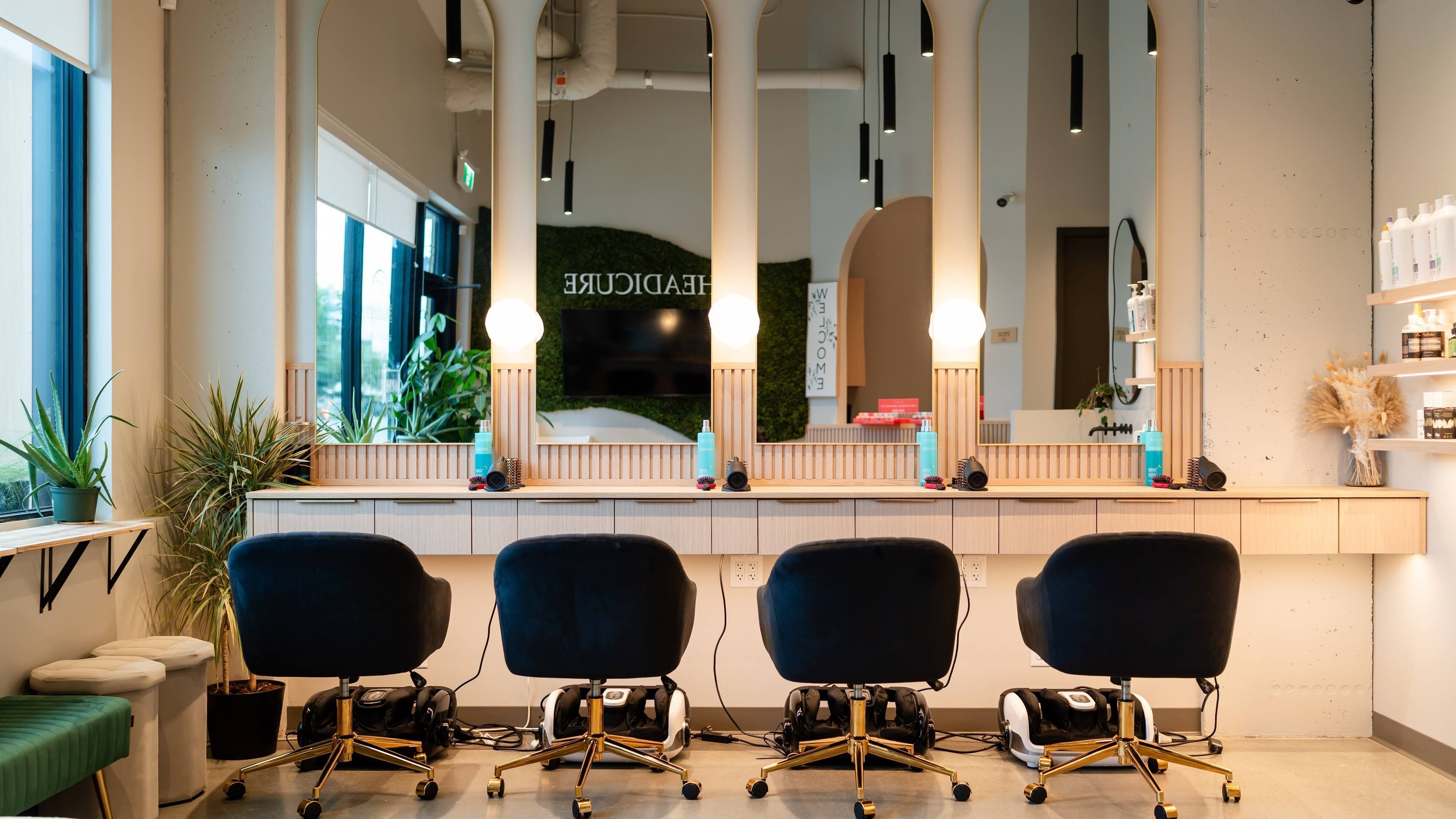 Chic interior of Headicure salon in Vancouver, British Columbia, CA featuring stylish black chairs and modern decor.