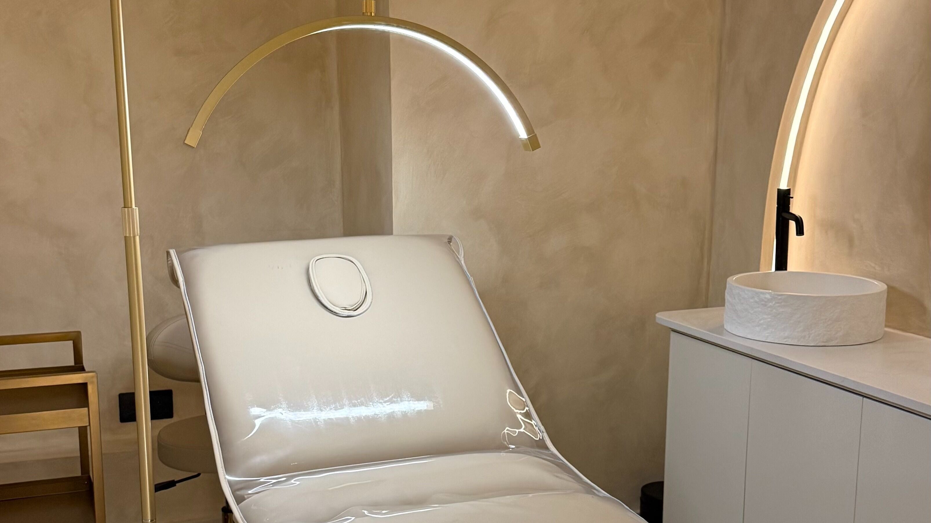 Luxurious treatment room at Face Lab London, London, England, GB, featuring a comfortable white chair and modern decor.