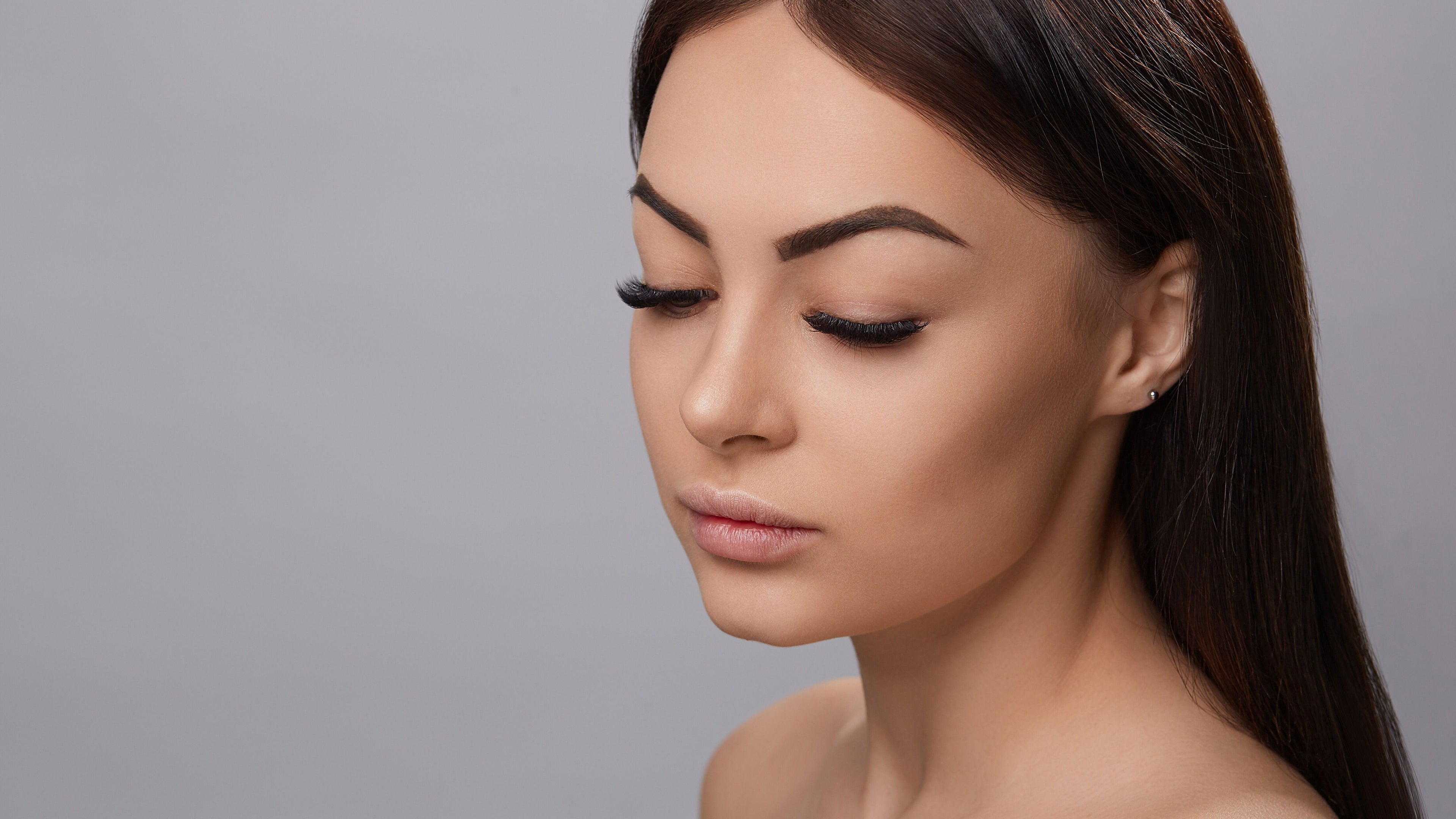 Woman with elegant eyelash extensions at Elite Lashes & Head Spa - De Zavala in San Antonio, Texas, US.