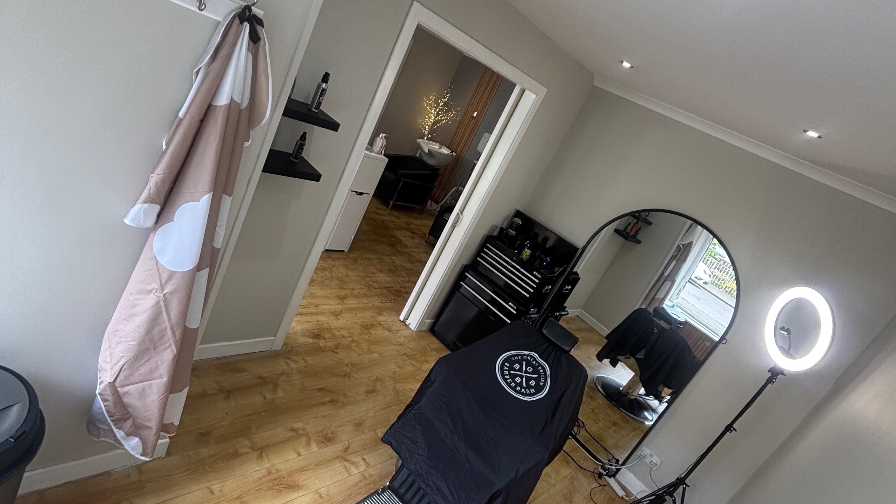 Modern interior of RB Studios in Bargeddie, Scotland, GB featuring salon chair, mirror, and warm lighting.