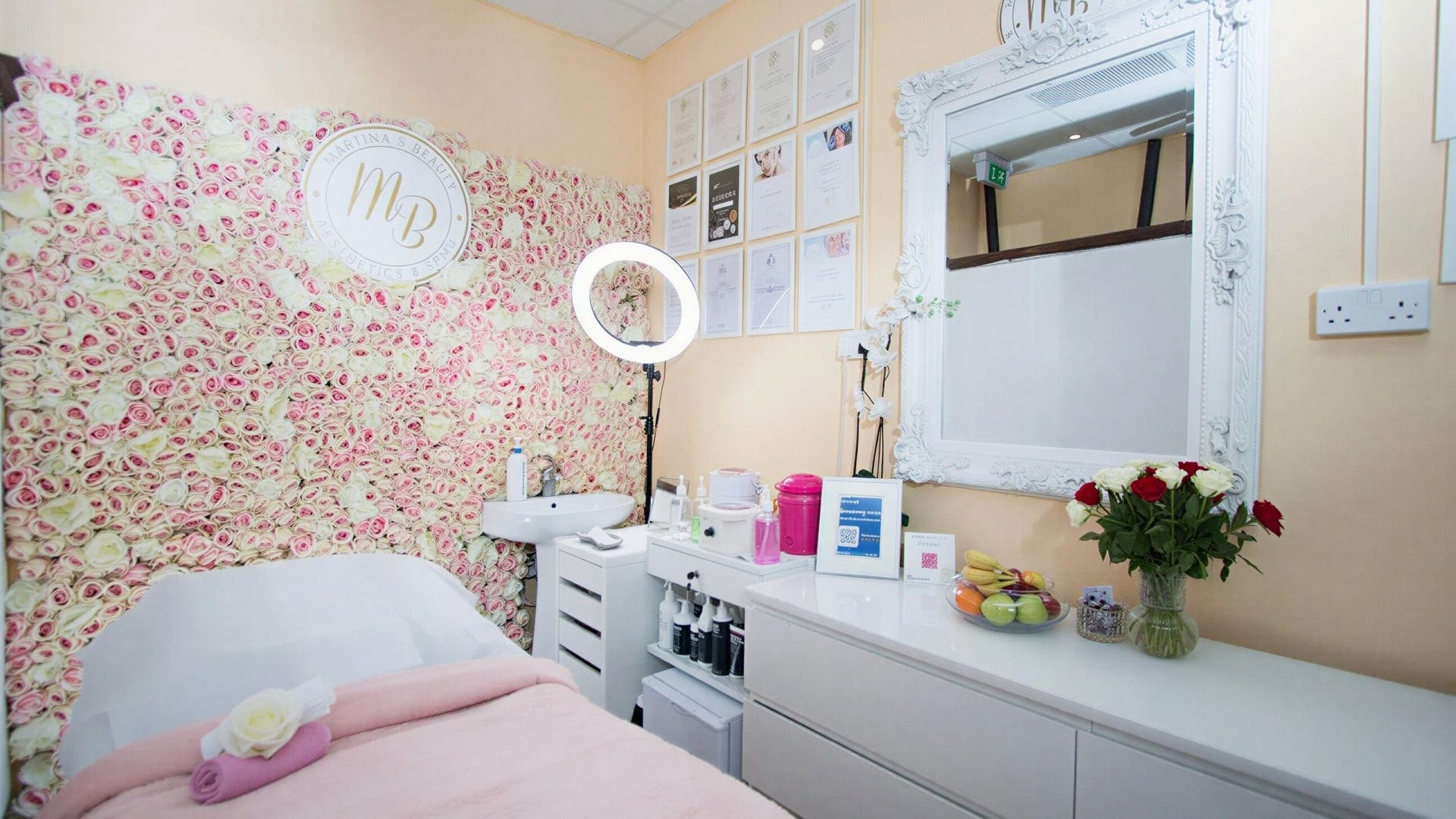 Elegant treatment room at Martina’s Beauty, Beckenham, England, GB, featuring a floral wall and serene ambience.