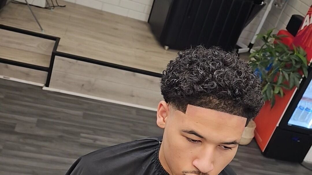Trendy haircut at Mkcuts7, Glasgow, Scotland, GB, showcasing a well-groomed curly hairstyle.