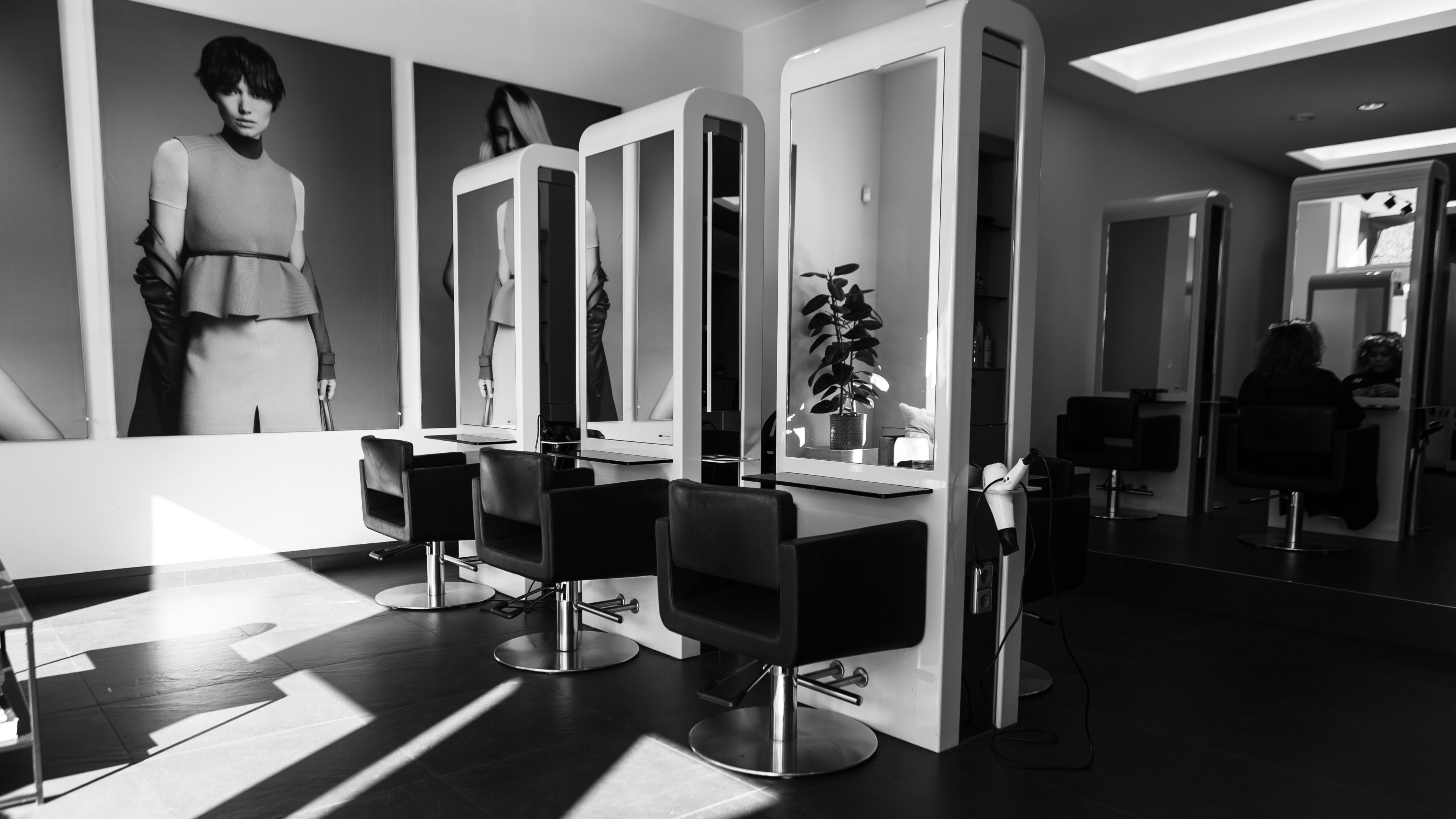 Chic salon interior at Room Hairdressing The Hague, Den Haag, Zuid-holland, NL with stylish chairs and mirrors.