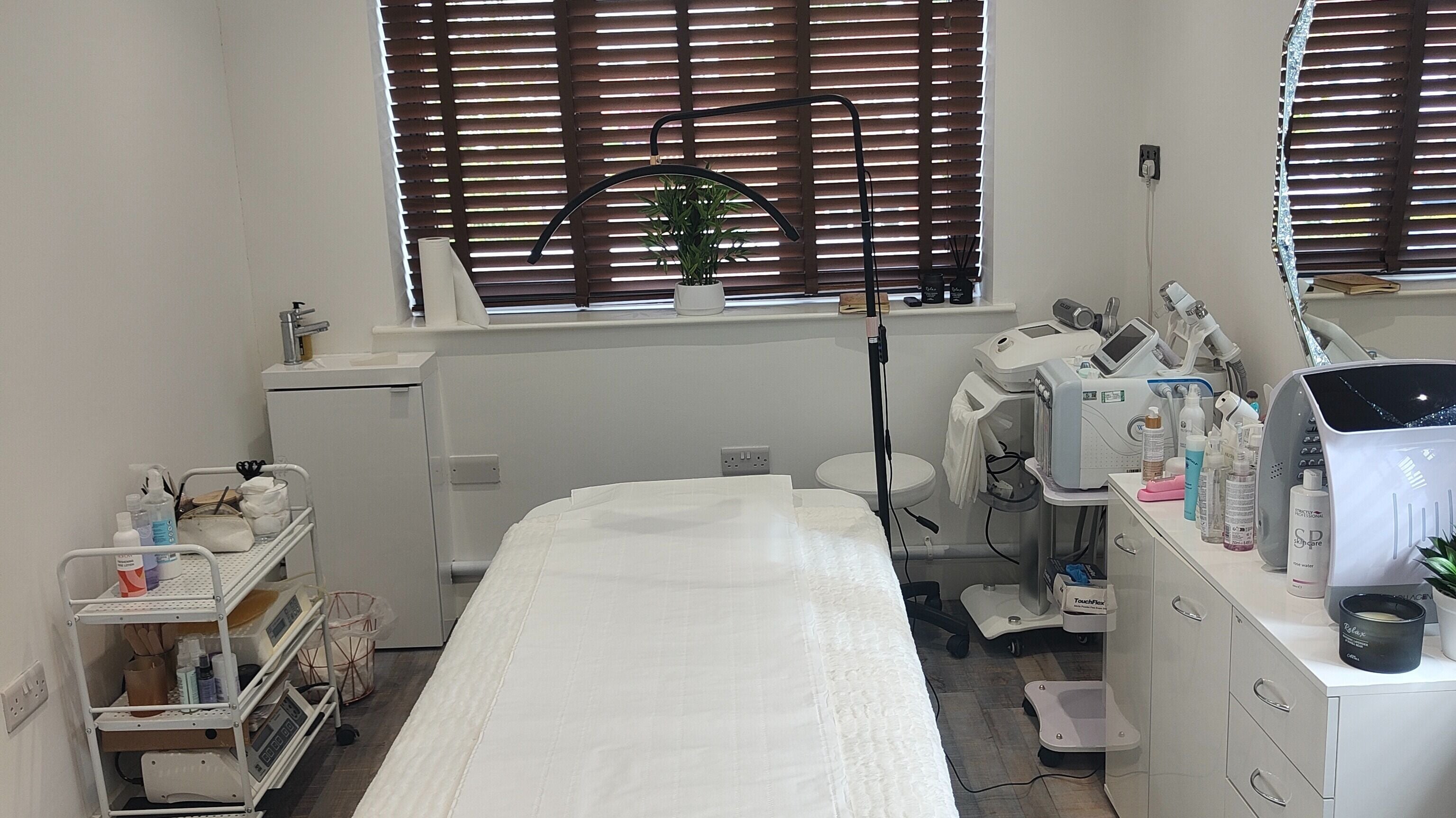 Tranquil treatment room at Reflection, Norwich, England, GB, with modern equipment and cozy ambiance.
