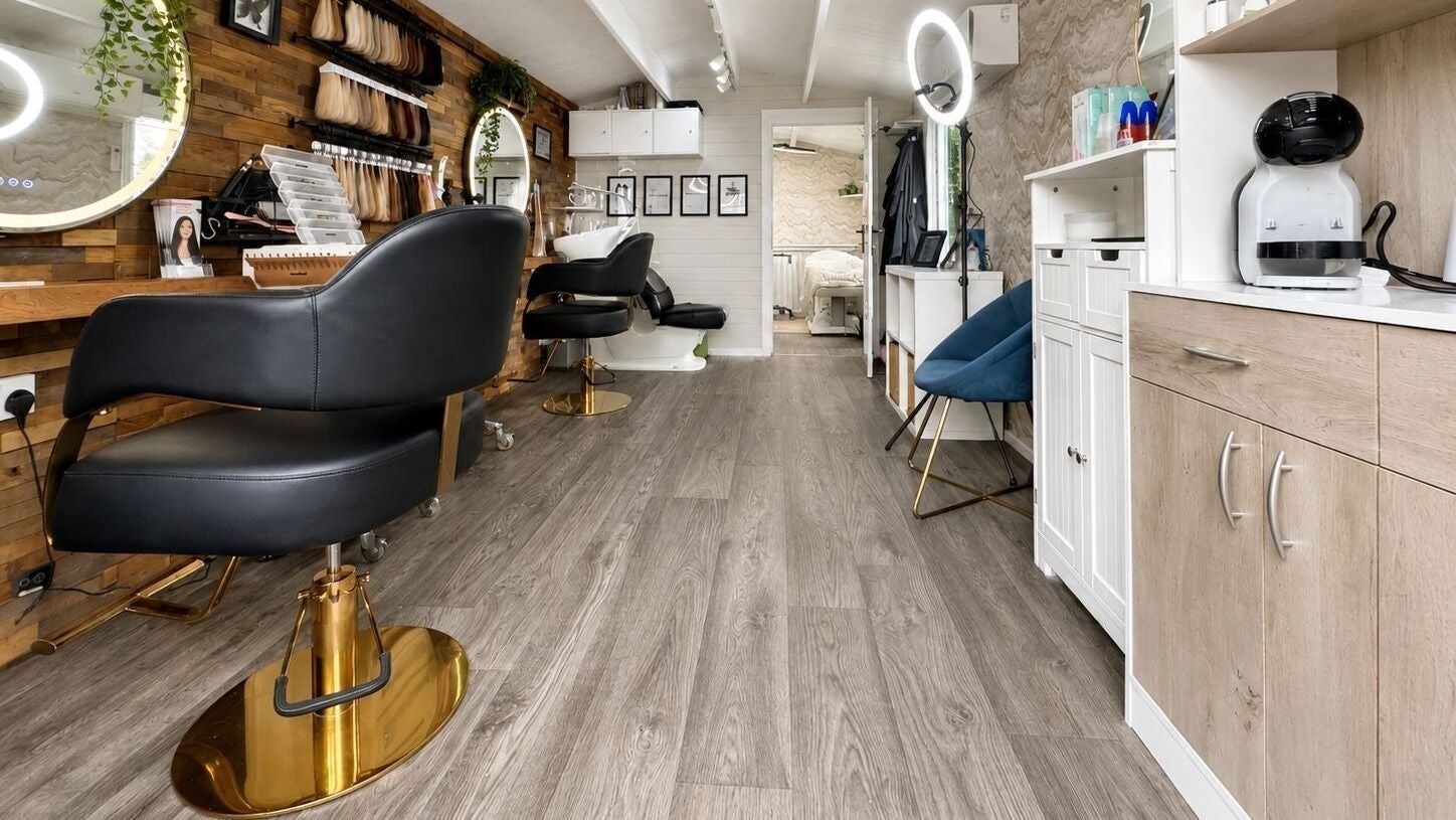 Modern salon interior at Jealous Beauty LTD, Epsom, England, GB with stylish chairs and wooden accents.