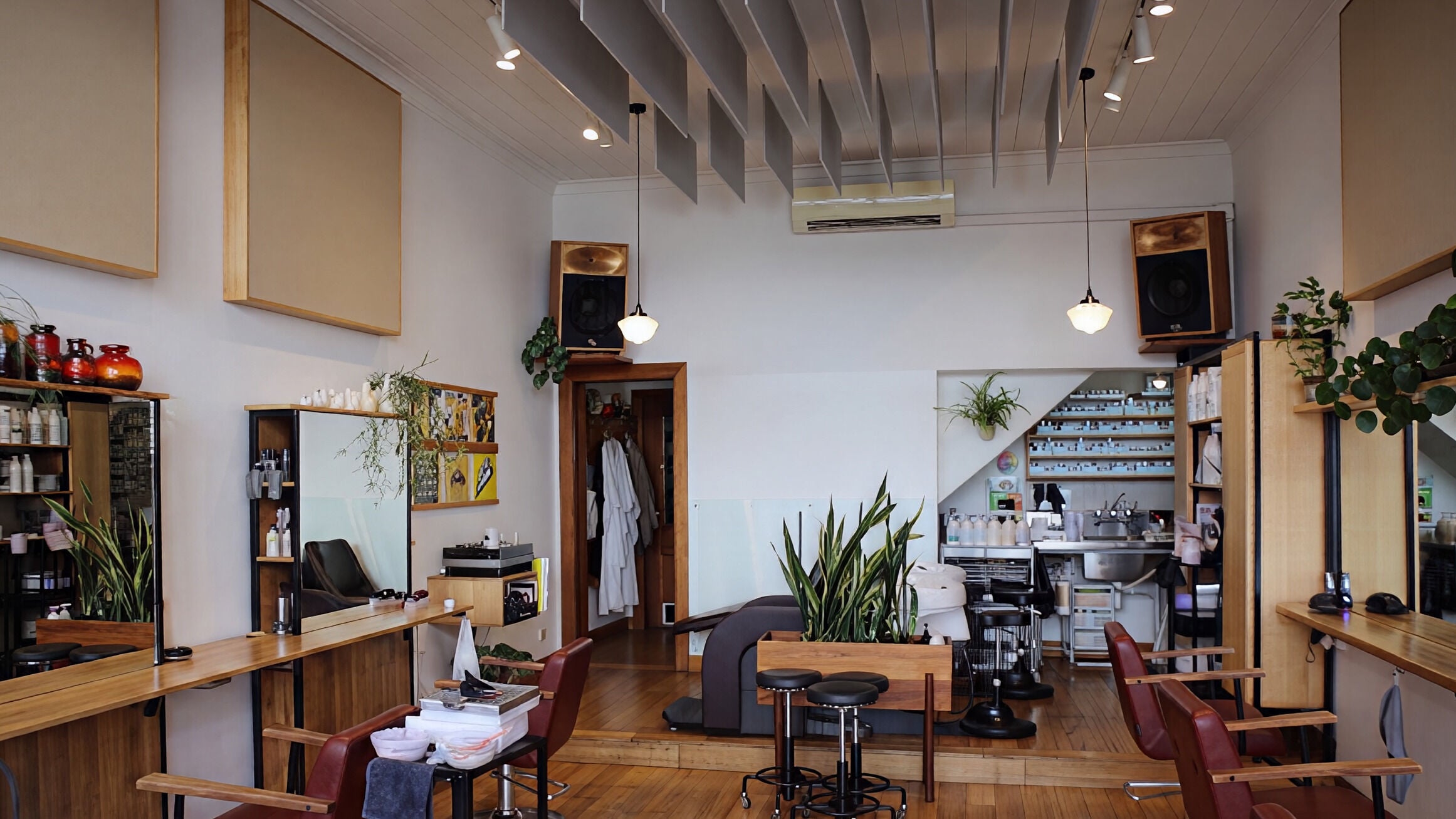 Chic interior of Little Buddha Pty Ltd, Collingwood, Victoria, AU. Wooden decor and lush plants create a serene atmosphere.