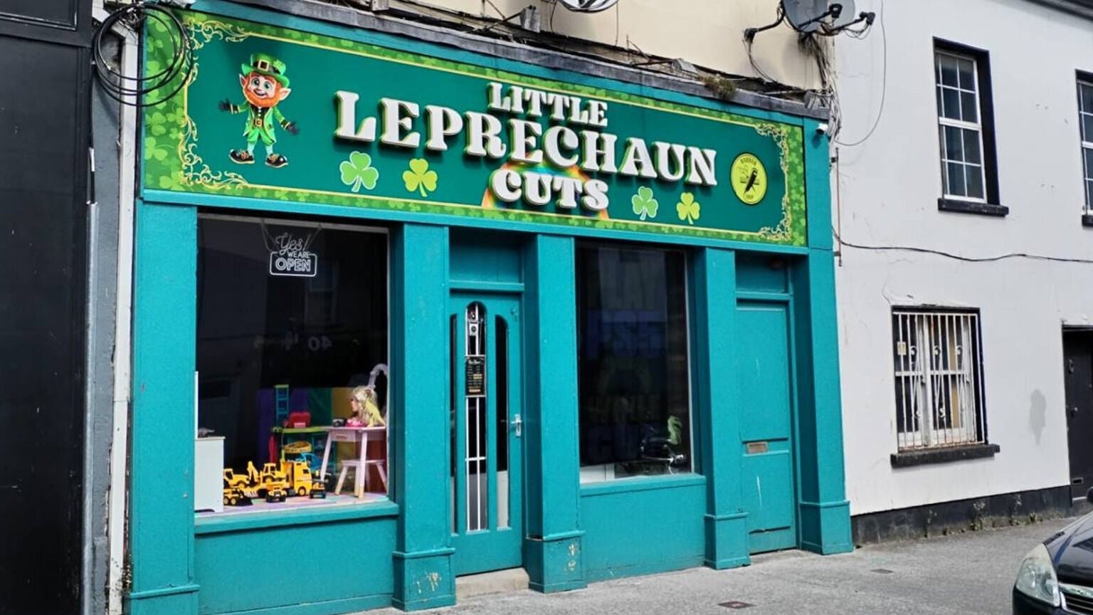 Exterior of Little Leprechaun Cuts, a vibrant hair salon in Limerick, County Limerick, IE with colorful signage.