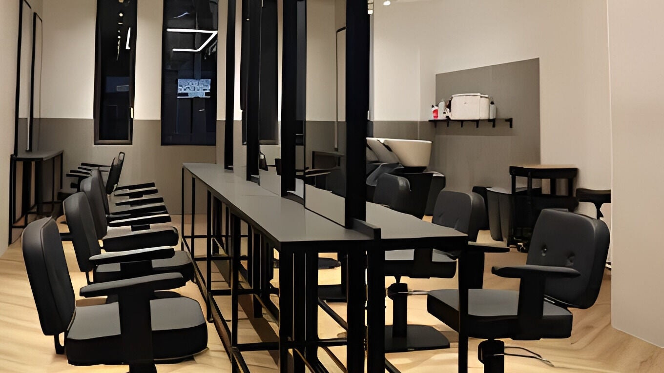 Stylish salon interior at Leo Wonderworks London, located in London, England, GB. Modern design and sleek seating.