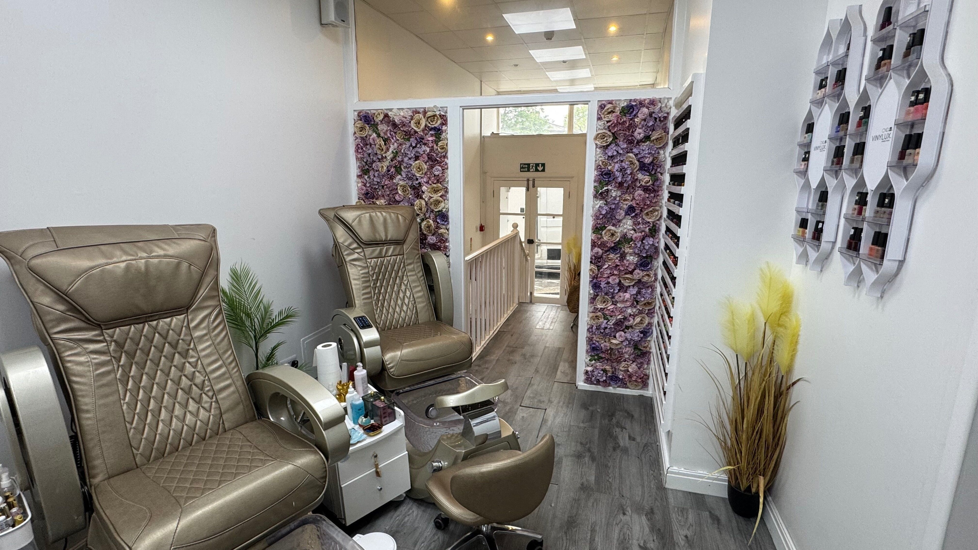 Elegant pedicure chairs at Lumi Nails in London, England, GB, featuring floral decor and serene ambiance.