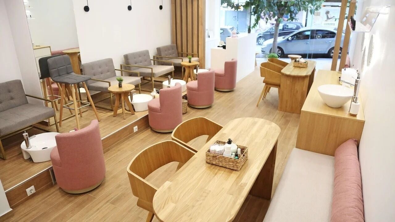 Κομψό εσωτερικό σαλόνι, Sweet Candies Nails Νέα Σμύρνη, Nea Smirni, GR με ροζ καρέκλες και μοντέρνα ξύλινα έπιπλα.