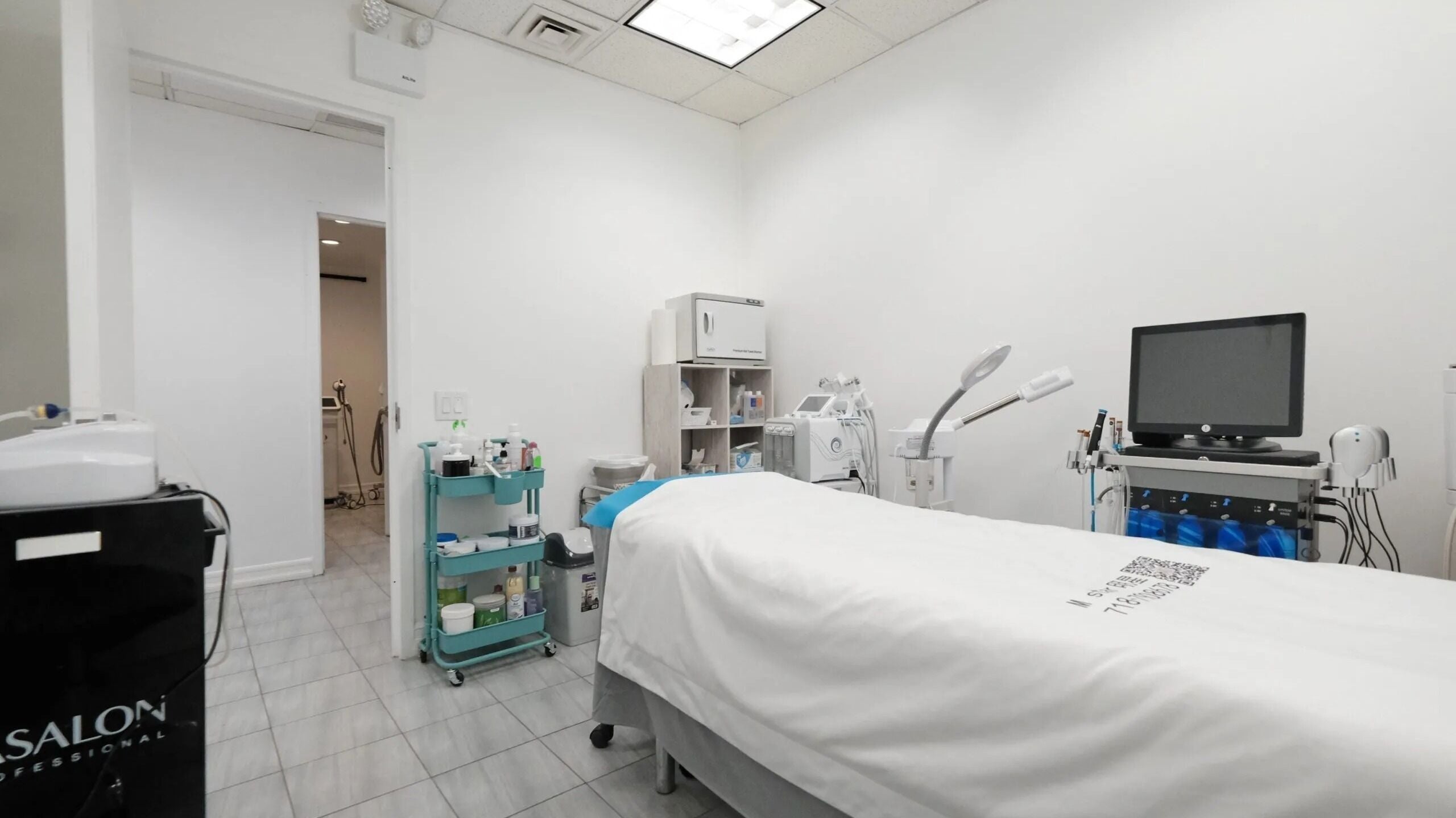 Modern treatment room at HQ Med Spa, New York, New York, US, featuring advanced beauty equipment and serene ambiance.