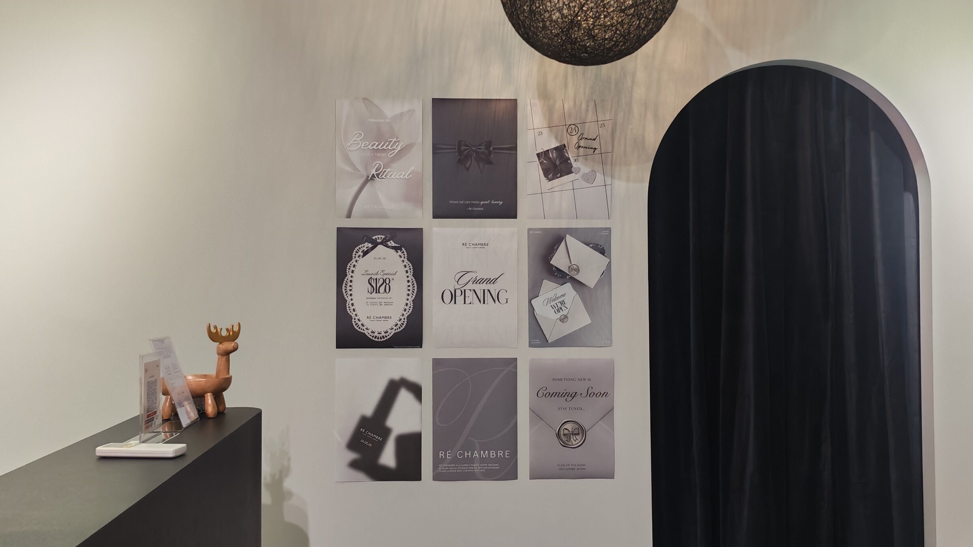 Sophisticated promotional wall at Ré Chambre, Singapore, SG, featuring elegant posters.