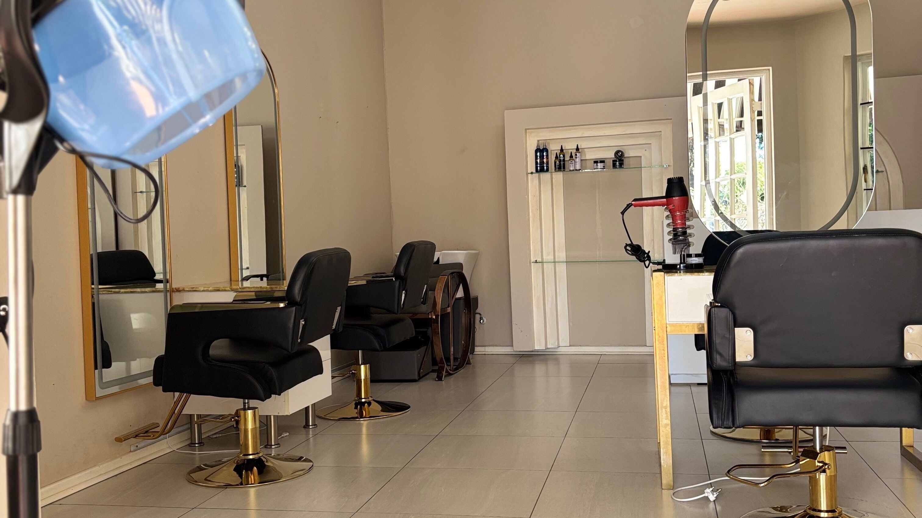 Cozy salon interior at Indalo Brooklyn Private Studio, Pretoria, Gauteng, ZA with stylish black chairs and hair equipment.
