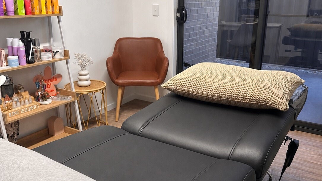 Beauty On Gerrand's tranquil treatment room in Latrobe, Tasmania, AU, featuring a plush massage bed and curated decor.
