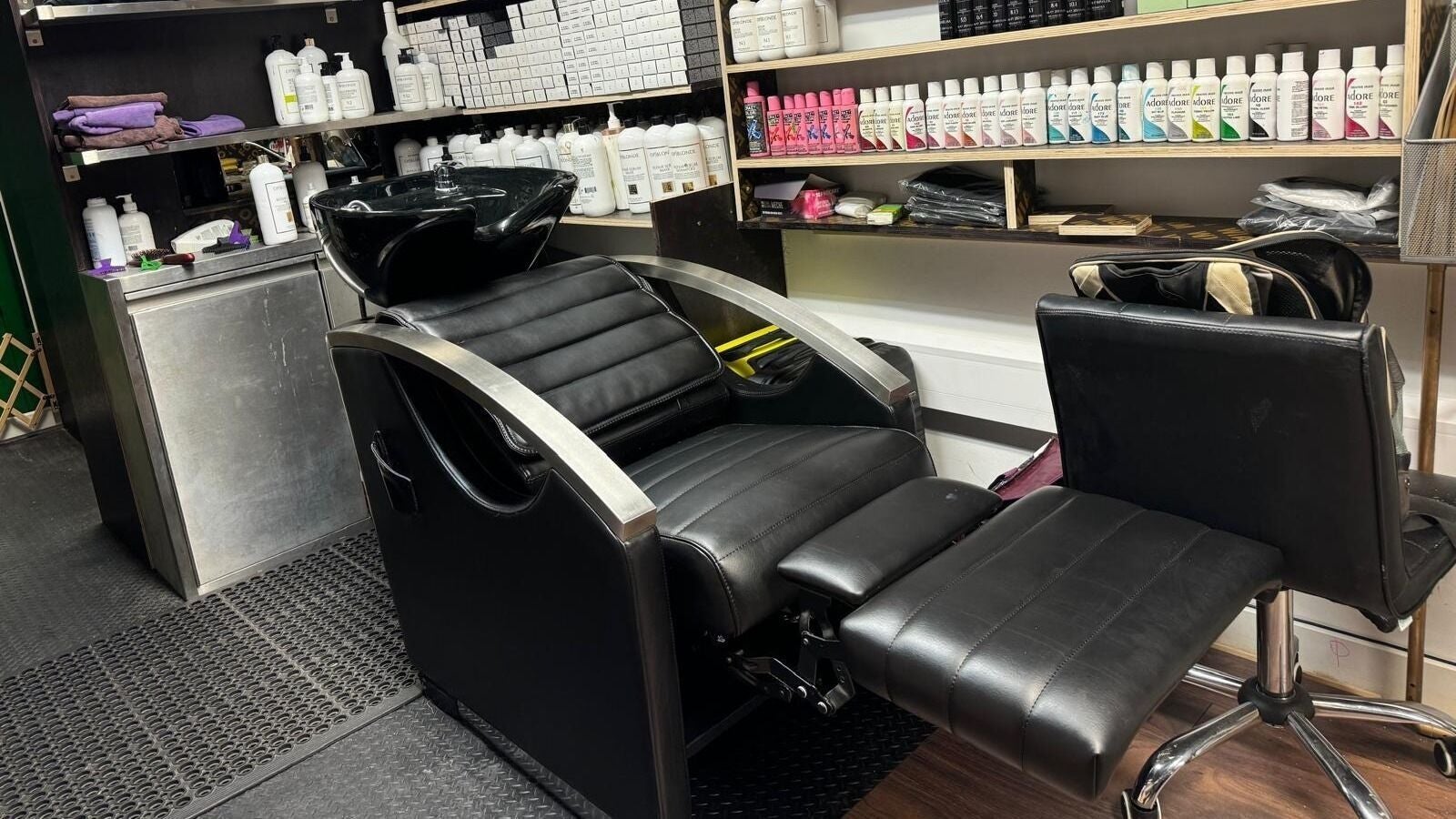 Modern salon chair at Scissorhands/OP Cosmetics London Ltd, London, England, GB, surrounded by hair care products.