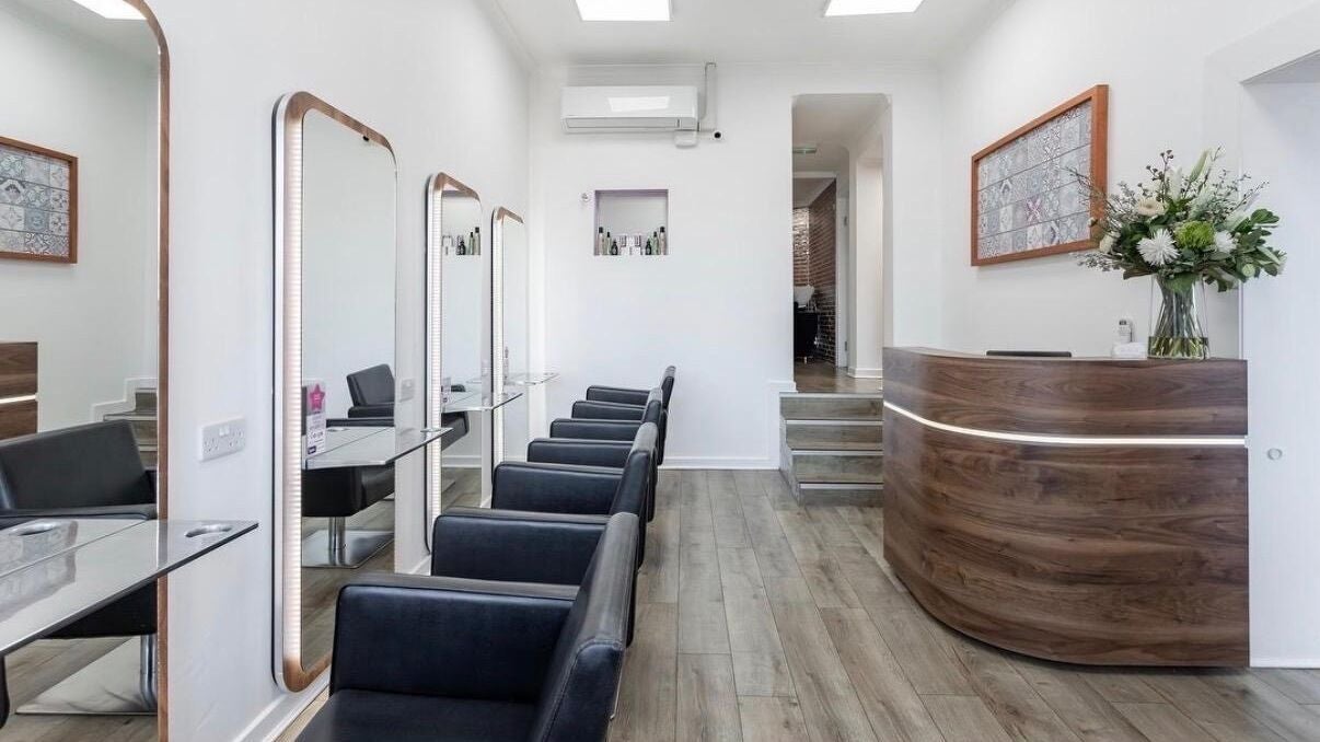 Modern salon interior at Amanda Bishop Hair, Glasgow, Scotland, GB, featuring sleek styling stations and elegant decor.