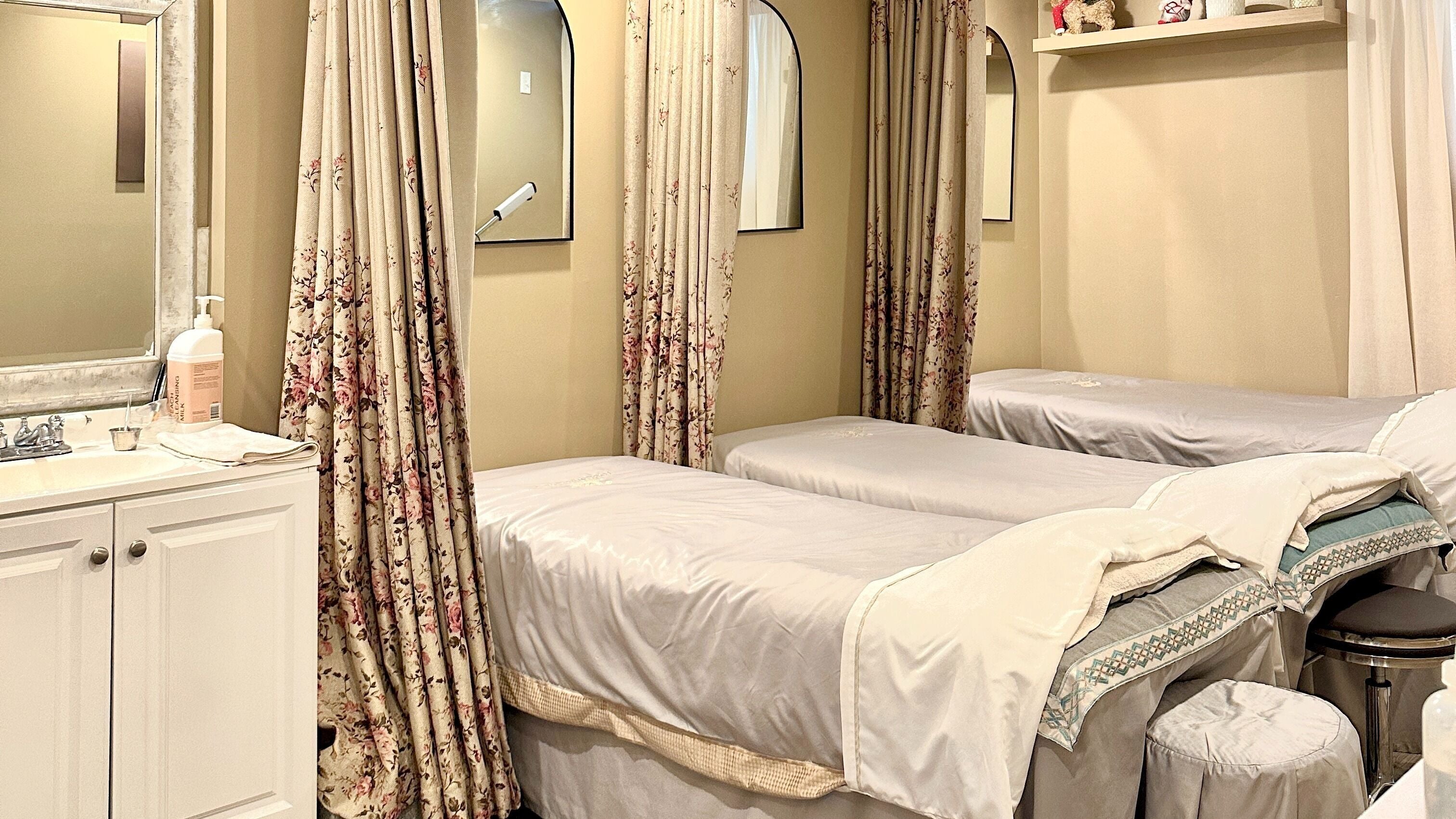 Tranquil massage room at Jing's Beauty, New York, New York, US, with elegant decor and cozy treatment beds.