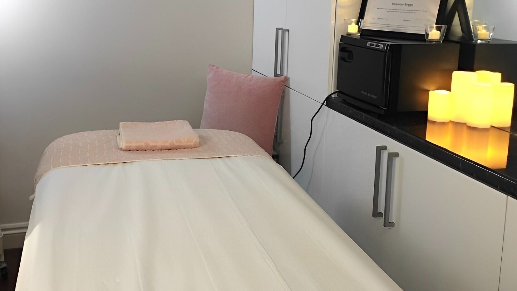 Tranquil massage room at The Powder Room, Cambridge, England, GB, featuring a cozy massage table and soft lighting.