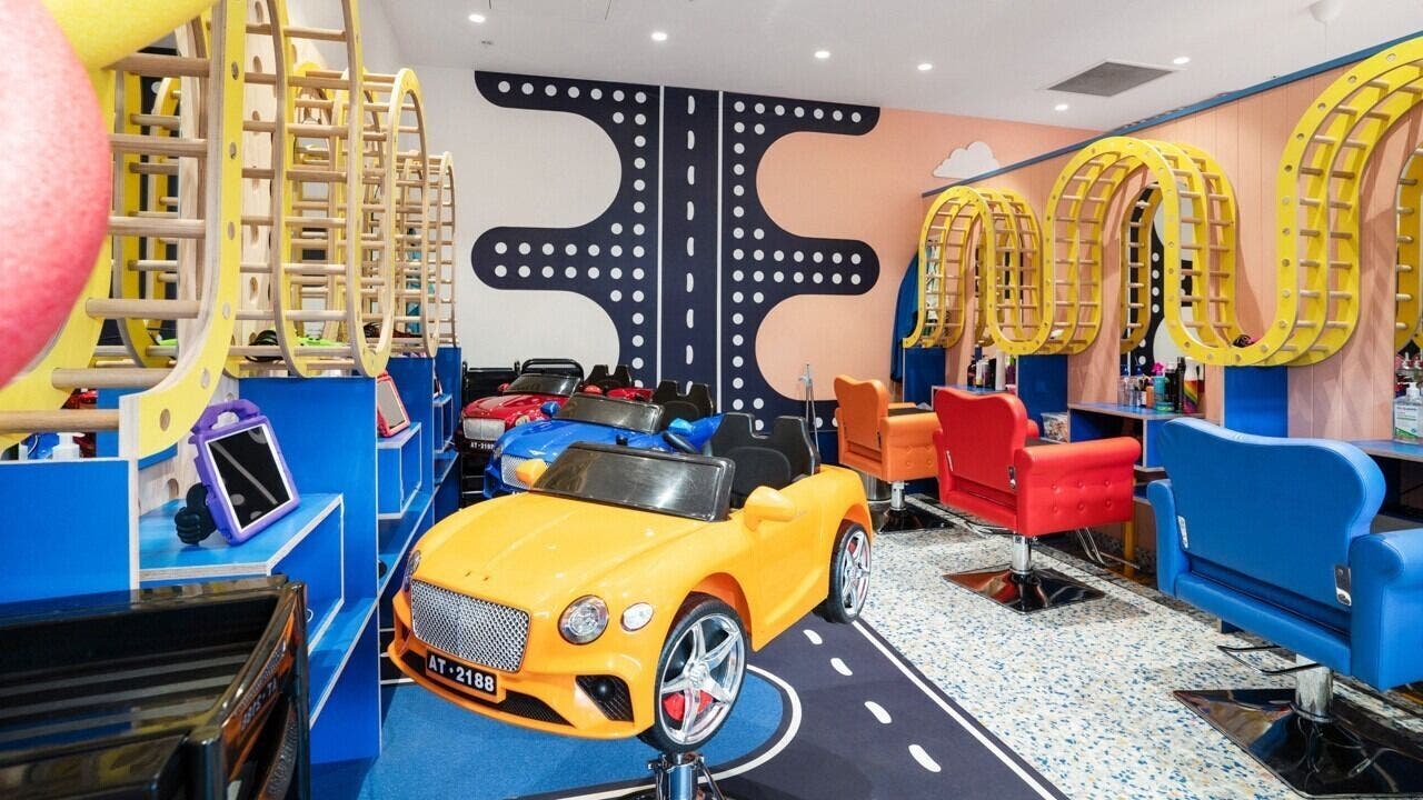 Vibrant kids' area at StarKids Salon Spa | Point Cook, Melbourne, Victoria, AU with car-themed seating.