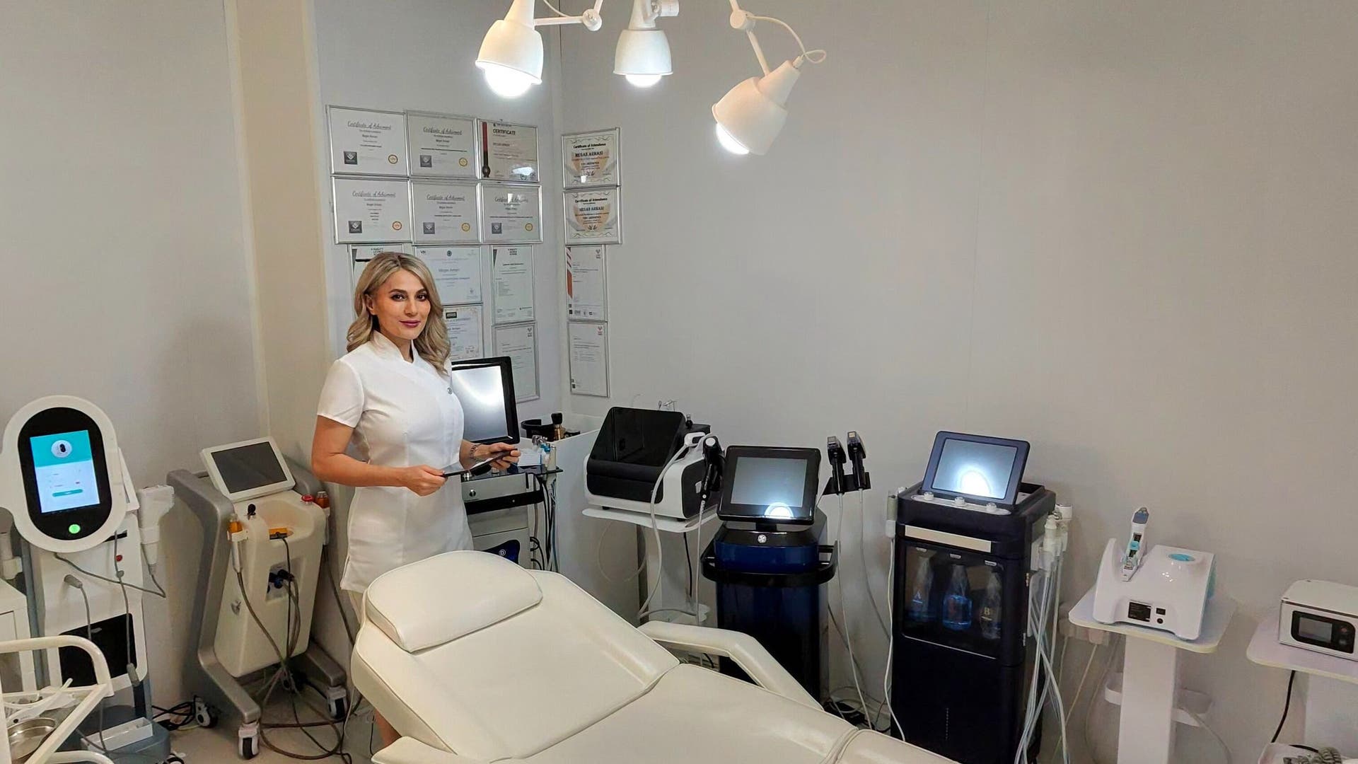 Aesthetician at Virgo Beauty & Skincare, Glasgow, Scotland, GB, in a modern treatment room with advanced equipment.