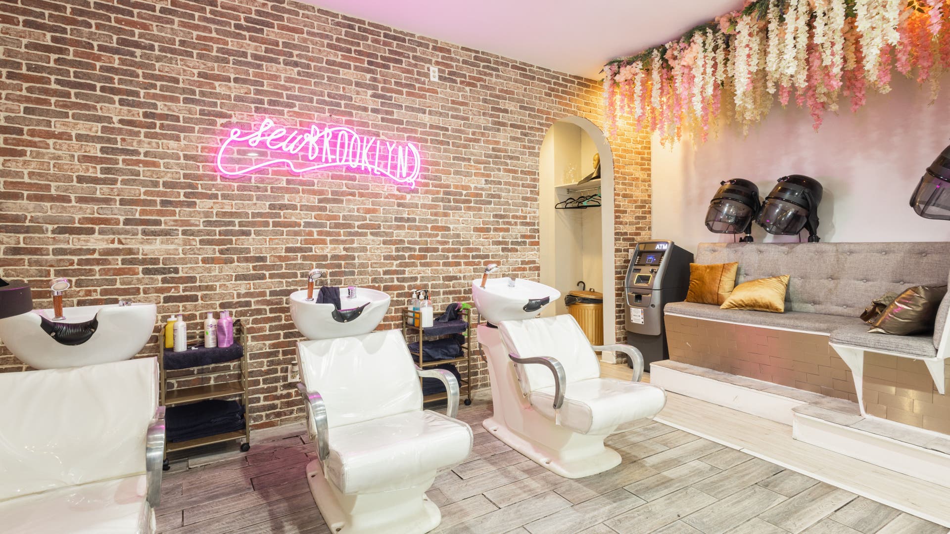 Modern hair washing area at Sew Brooklyn Hair Extension Lounge in New York, New York, US, with stylish decor.