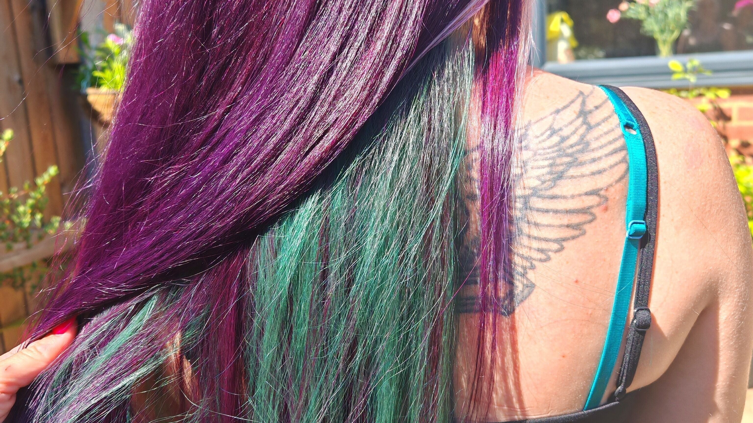 Vibrant purple and green hair coloring at Dannielle's Cutting Edge in Littlestone, England, GB.