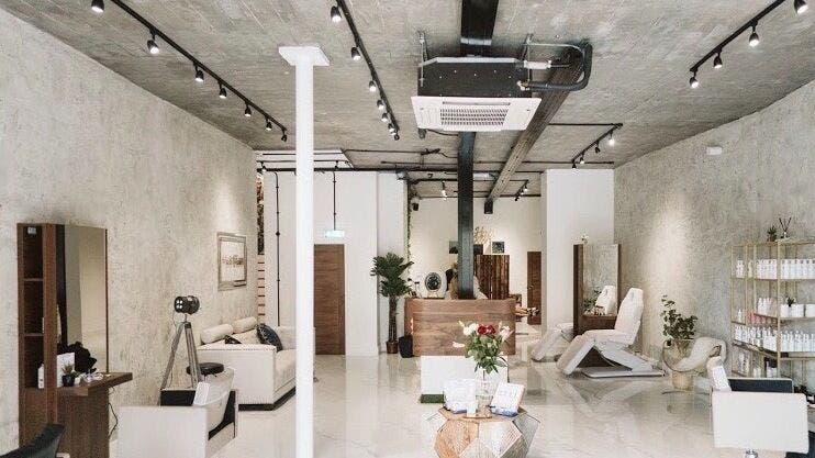 Modern beauty salon interior of Laura Louise in London, England, GB with stylish decor and treatment chairs.