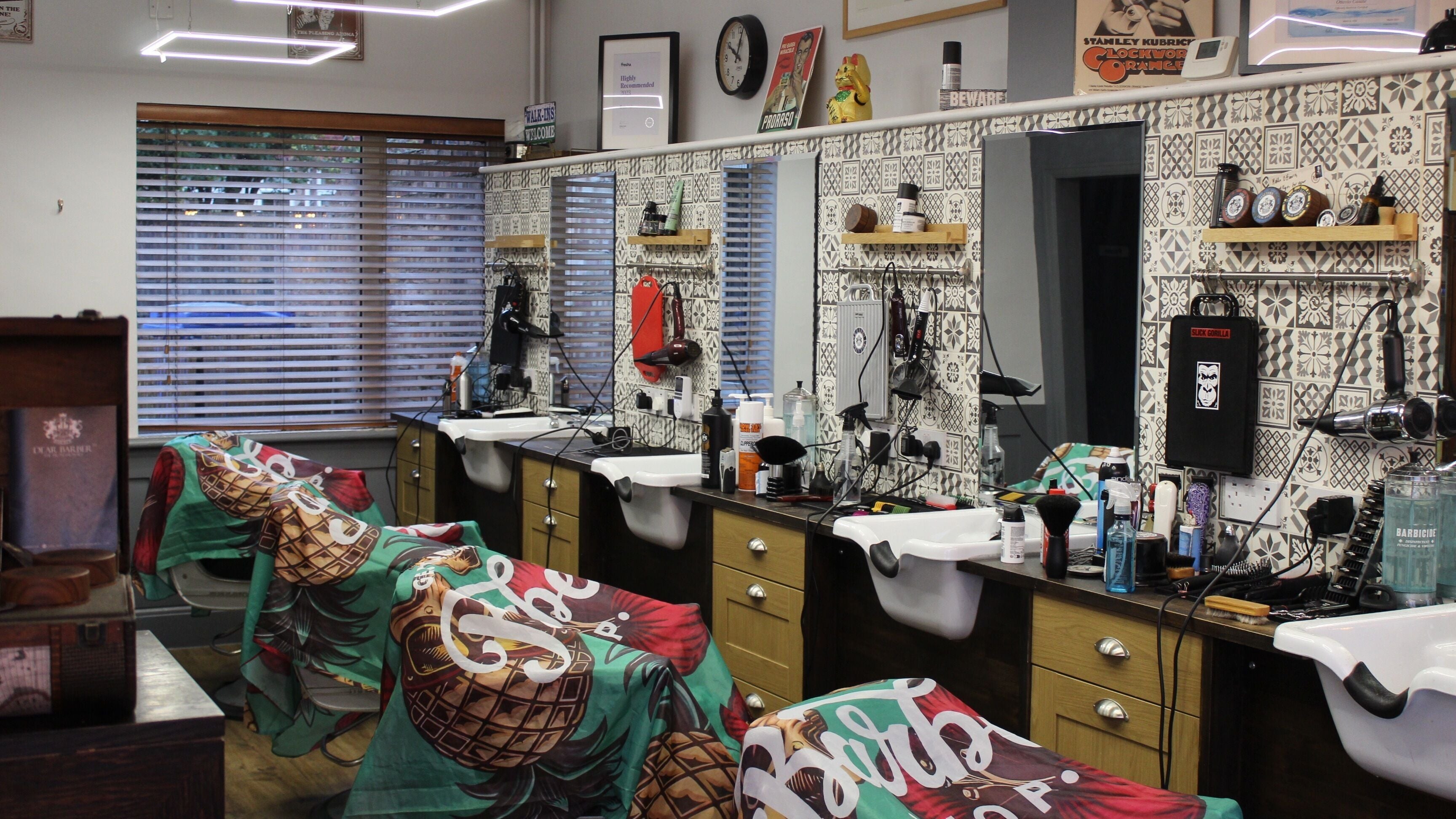 Trendy barber chairs and stations at Enzo Hair, Norwich, England, GB, highlighting a stylish interior.
