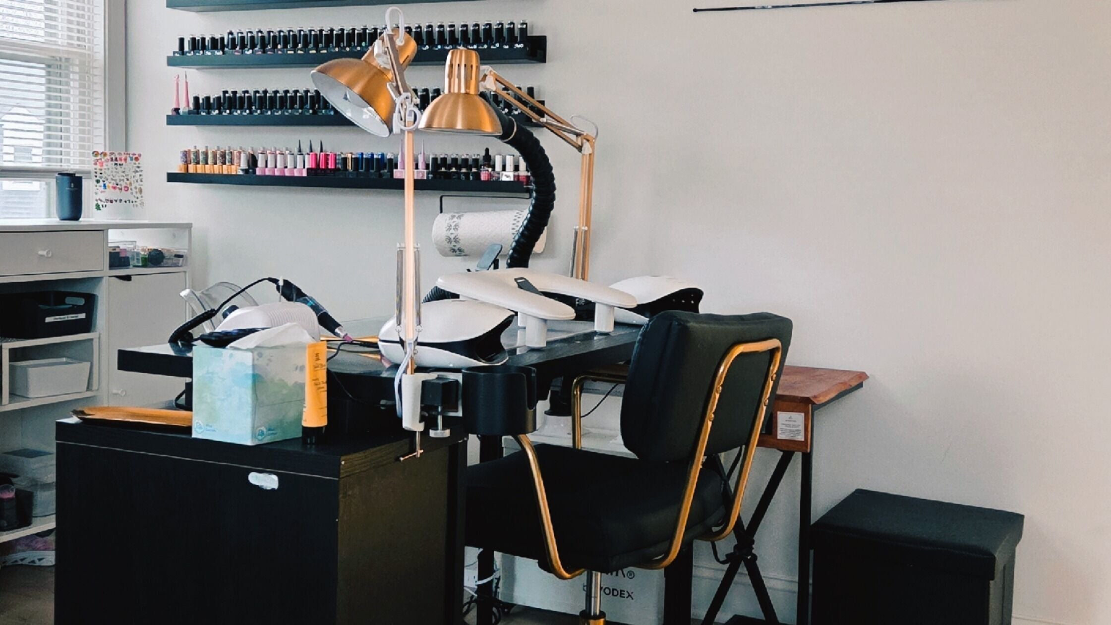 Elegant manicure station at Celeste's Nail Studio, Fairfax, Virginia, US, showcasing modern decor and nail polish display.