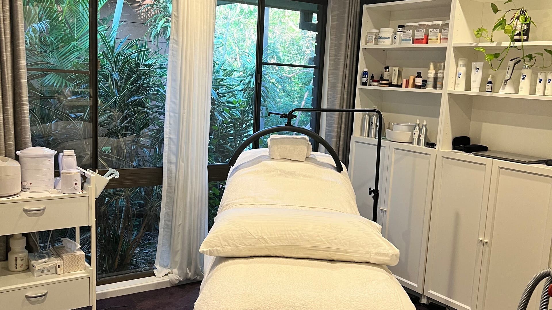 Spa treatment room at Beauty By Roslyn, Mount Crosby, Queensland, AU with lush greenery and serene decor.