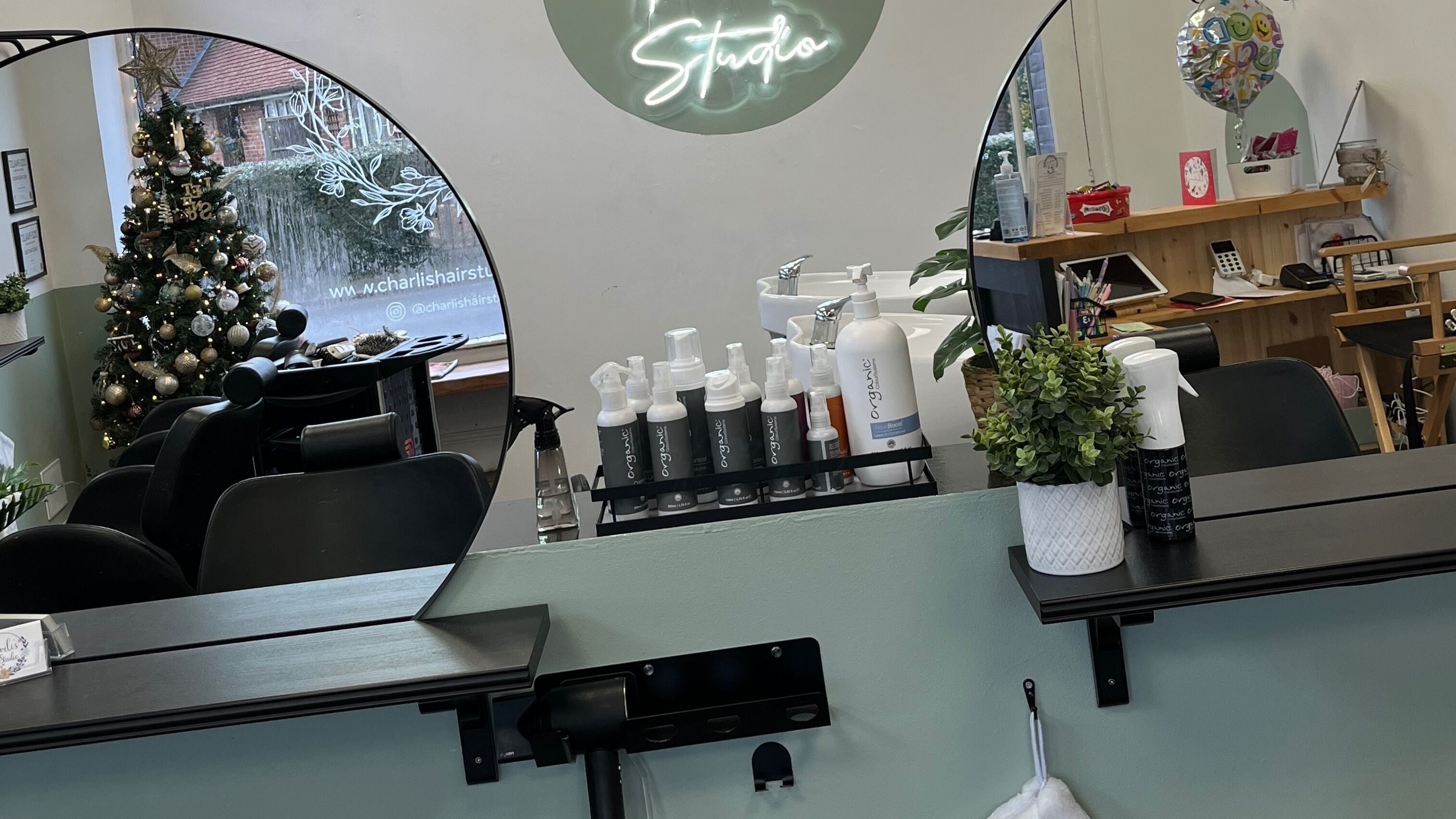 Interior of Charli's Hair Studio in Beccles, England, decked with holiday decor and styling products.