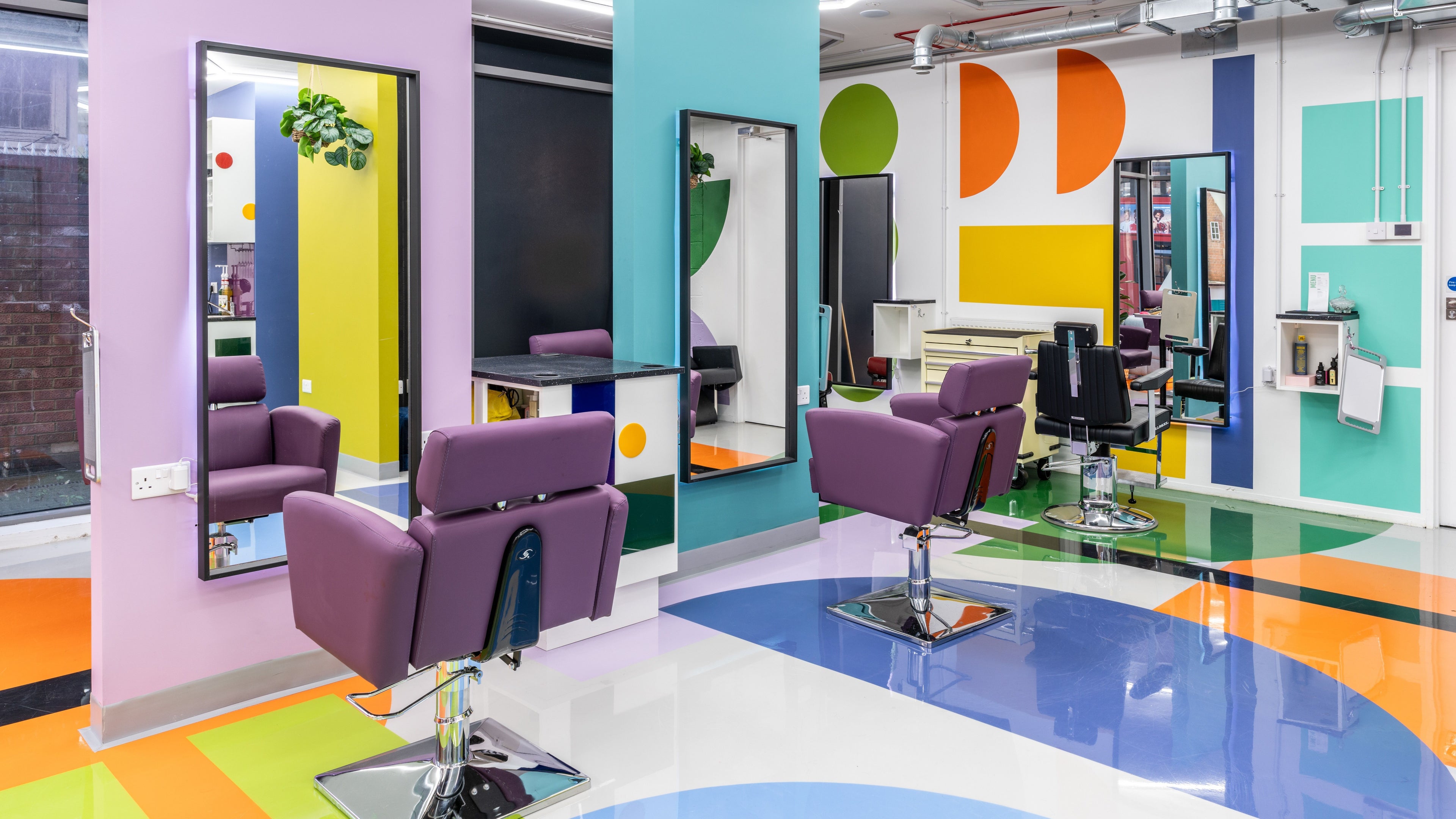 Colorful salon interior at Fruittii London in London, England, GB, with chic chairs and modern decor.