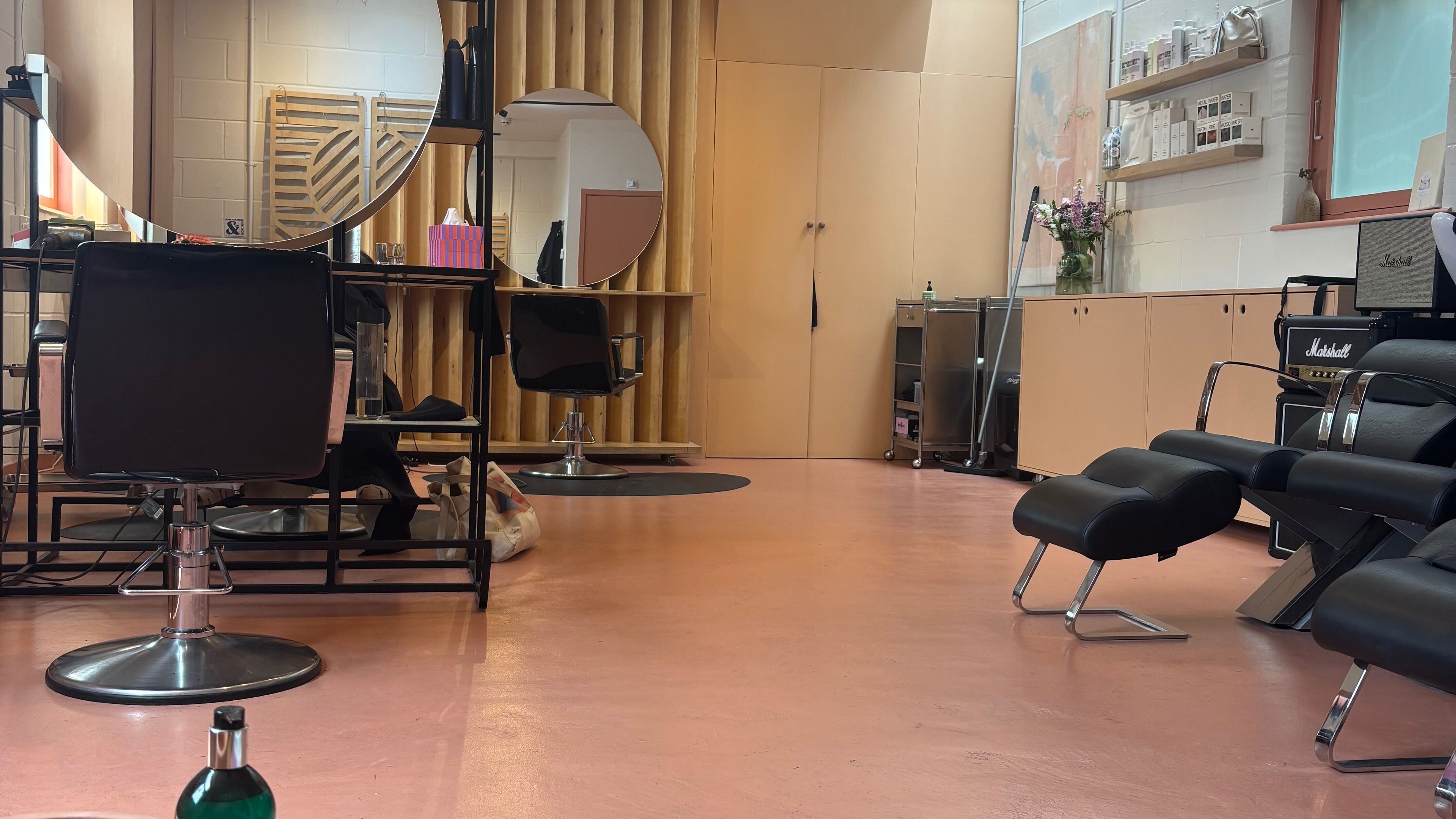 Modern interior of Mane Hackney salon, London, England, GB with stylish chairs and mirrors.