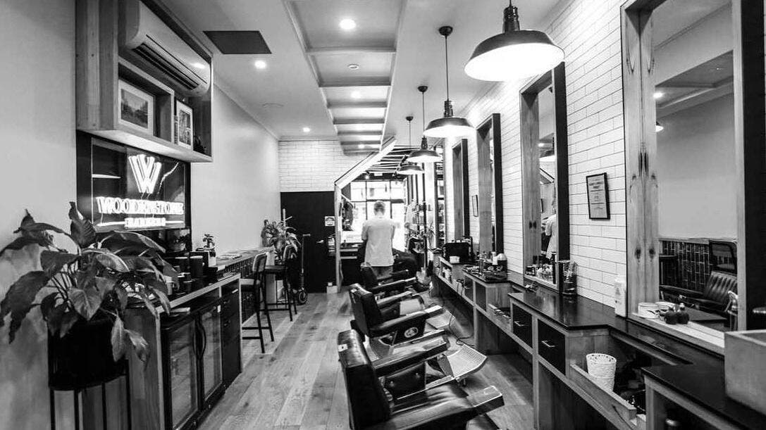 Elegant interior of Woodenstone Barbers, Byron Bay, New South Wales, AU with classic barber chairs and stylish decor.