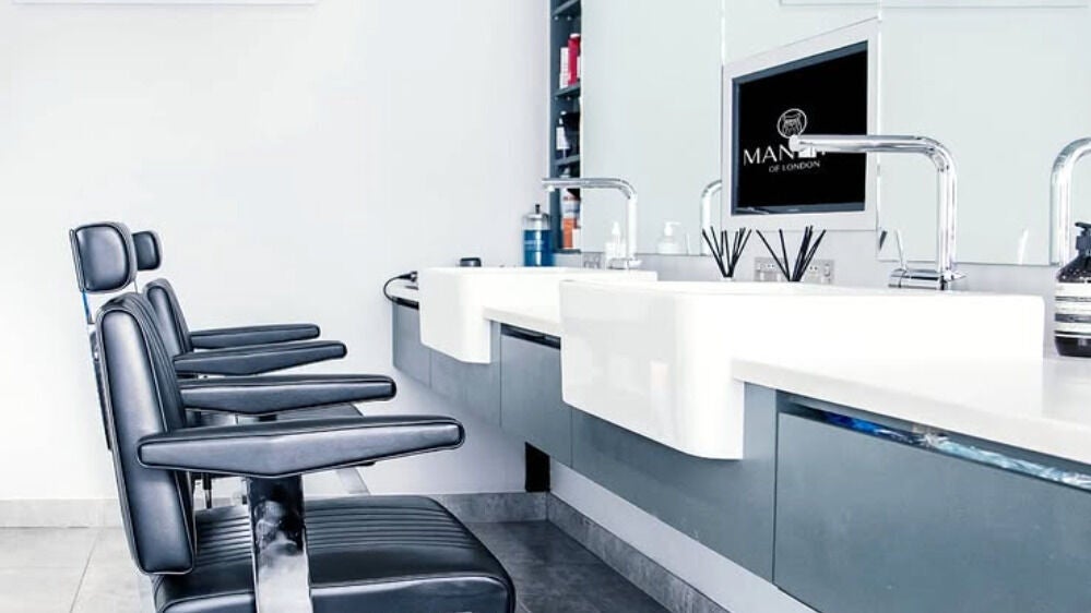 Elegant salon chairs and sleek sinks in Manny's of London, located in London, England, GB, showcasing modern design.